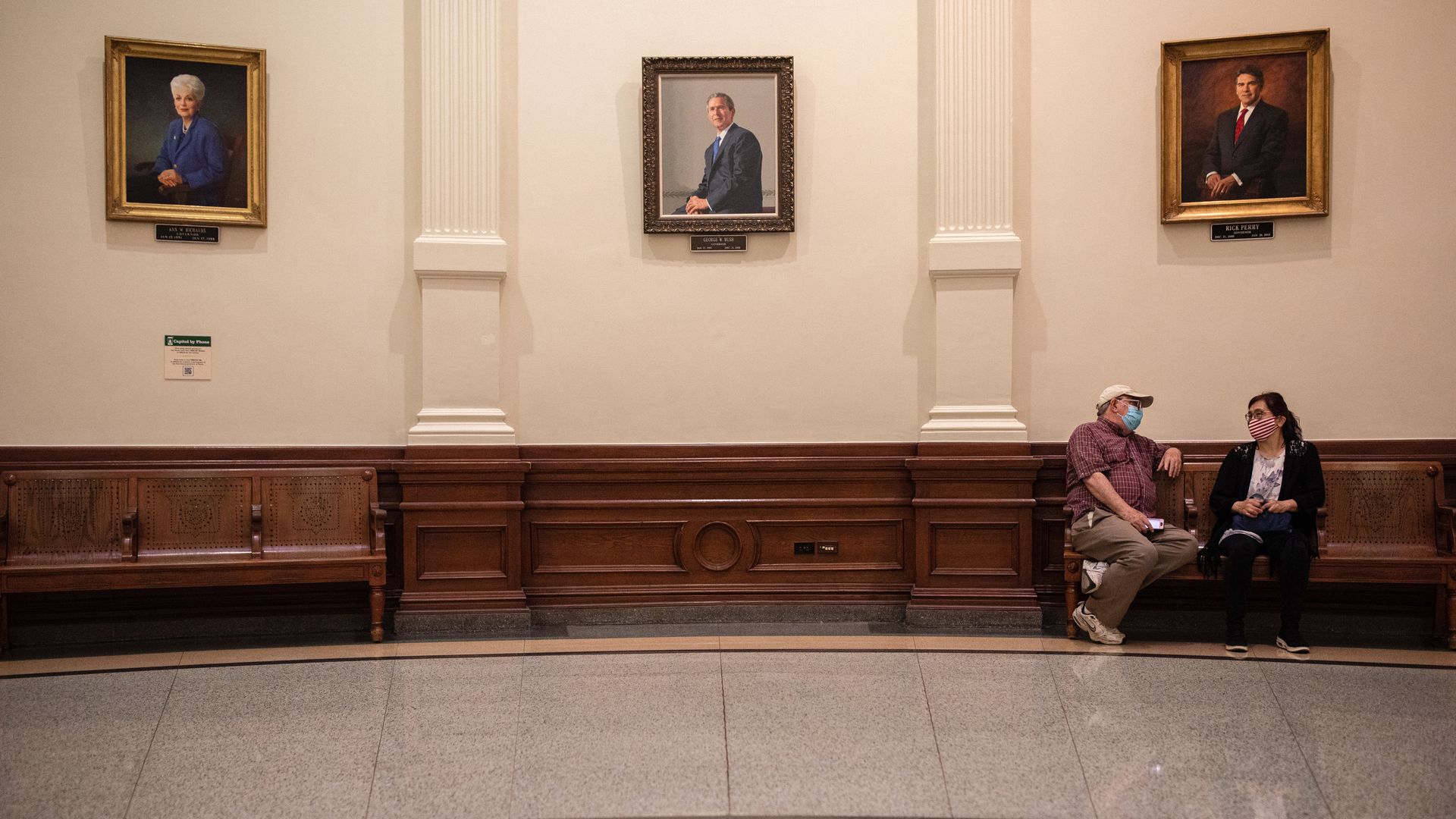 People wearing masks inside the Texas state Capitol building in Austin on March 10.