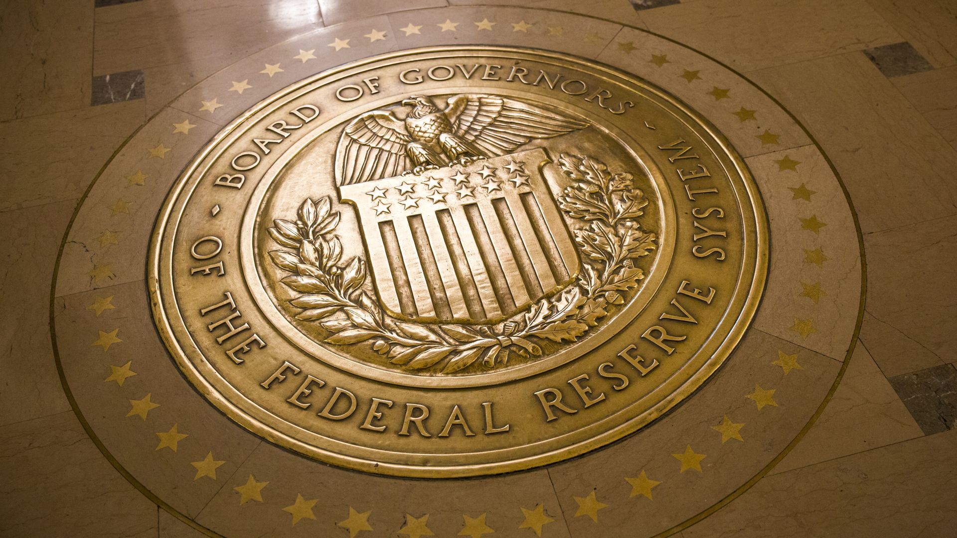 Gold-plated seal of the United States Federal Reserve.