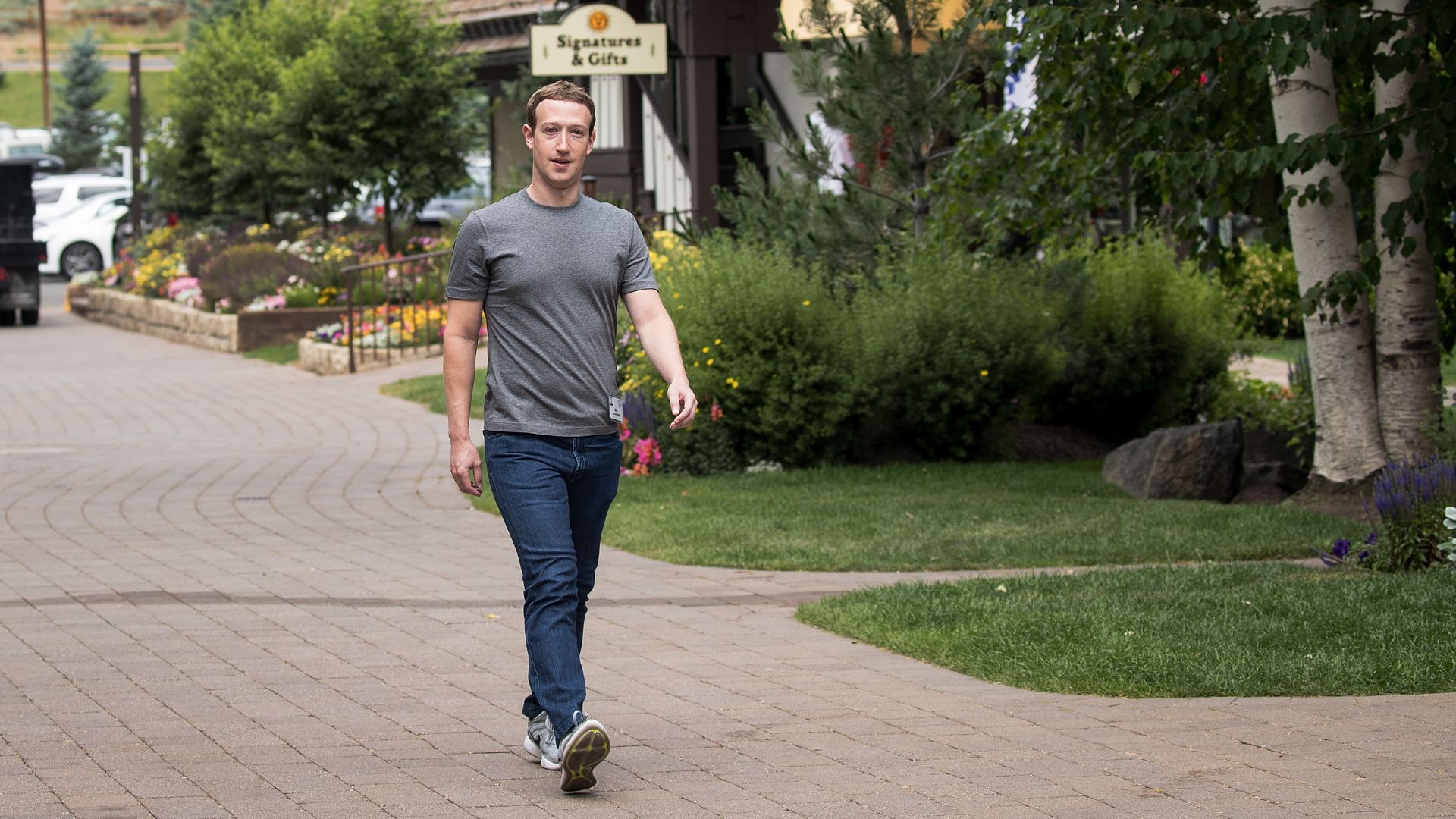 Mark Zuckerberg walks through a town