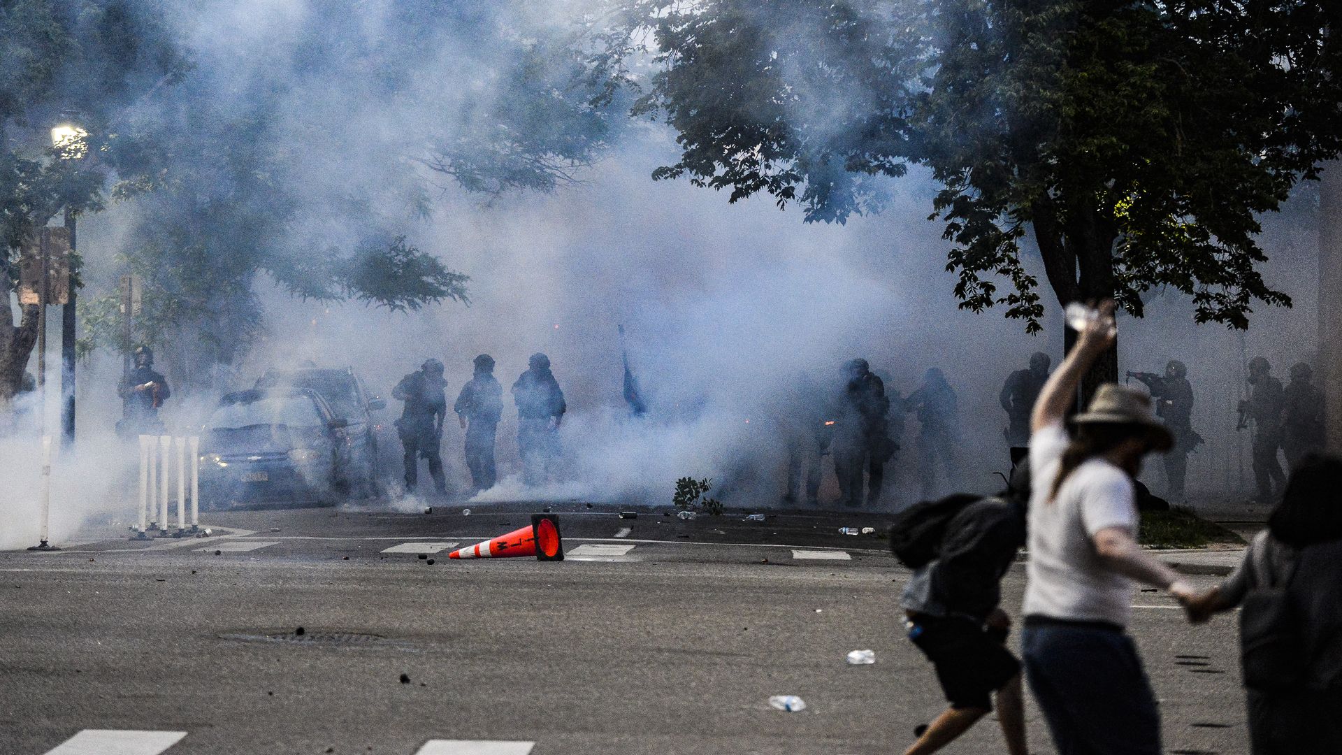  Police officers stand behind a wall of tear gas during protest in Denver in May 2020. Photo: Michael Ciaglo/Getty Images