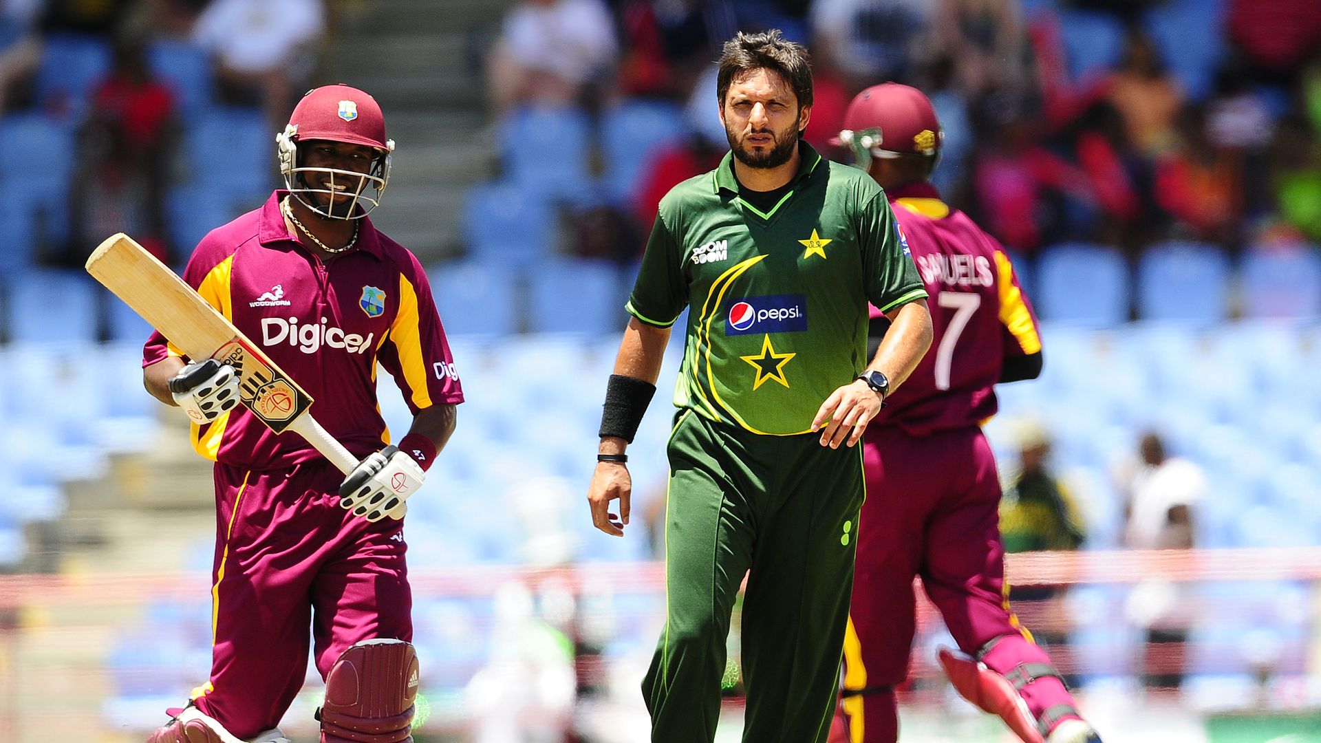 Two cricket players, one wearing a bat and helmet