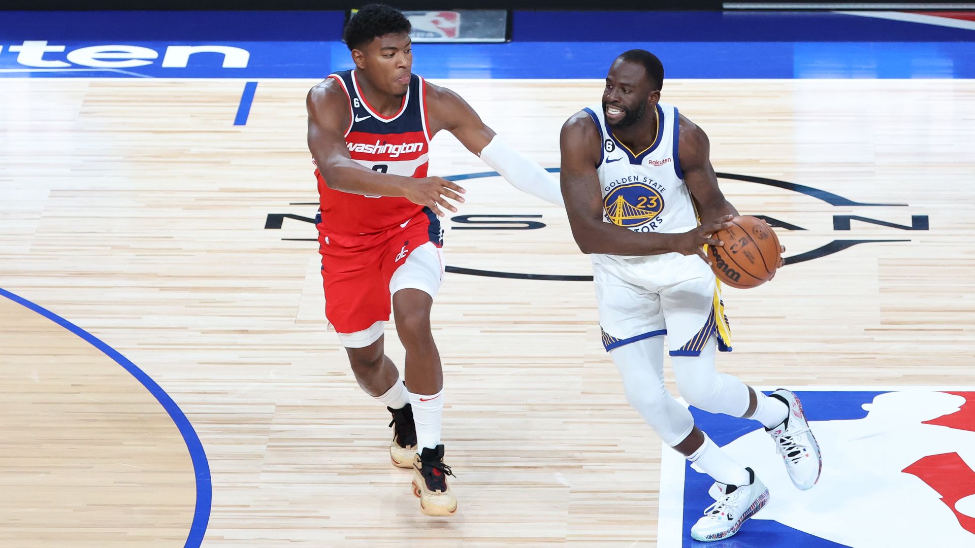Draymond Green with ball in hand wearing the white Warriors jersey