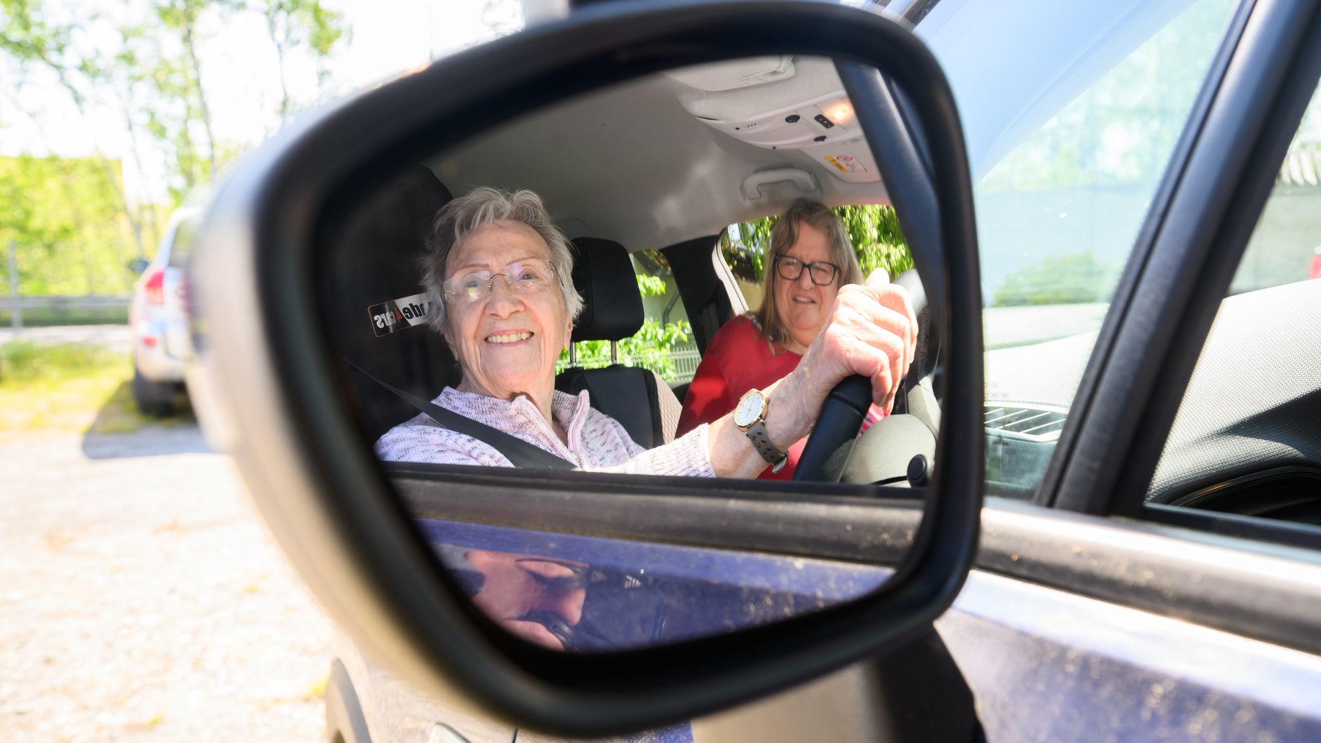 A photo of a woman driving a car.