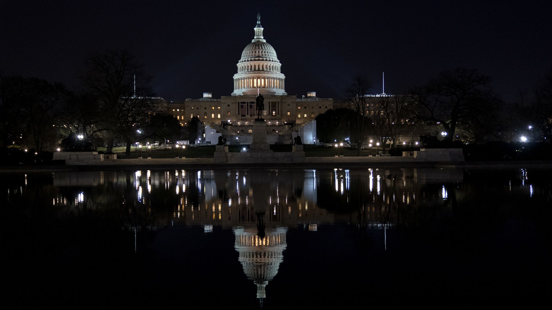 The Capitol is seen reflected back in a pool on its West side tonight.