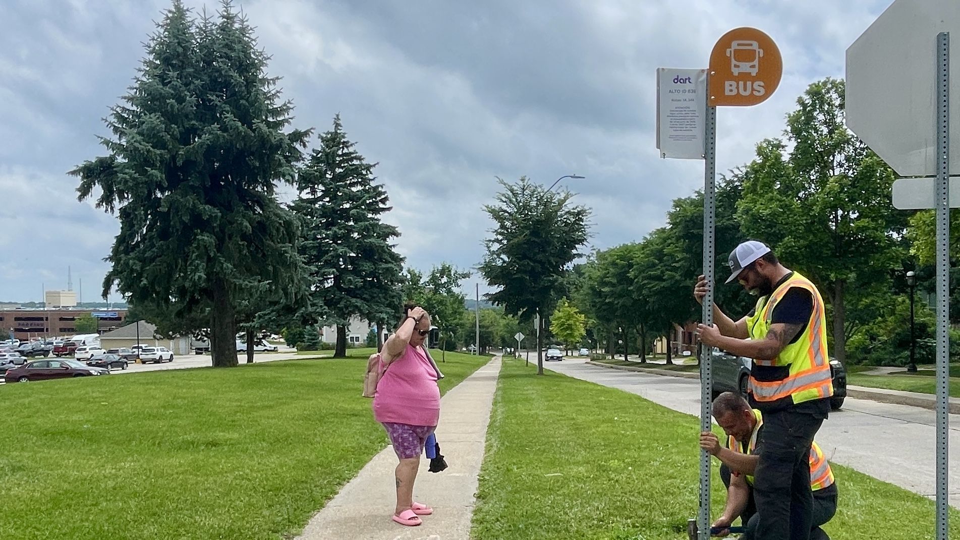 A photo of a bus sign getting updated.