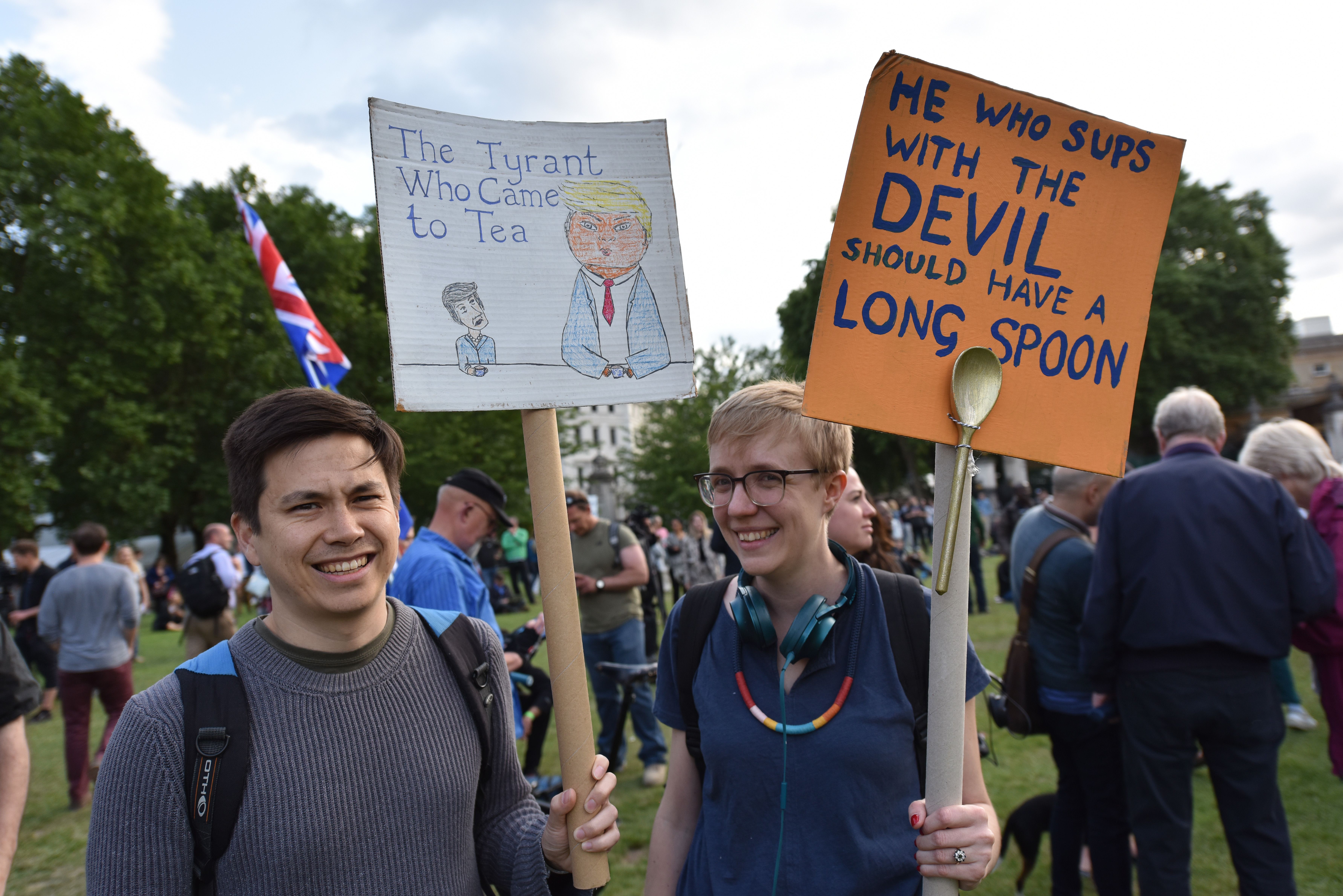 Protesters hold placards in protest over Donald Trump's state visit during as Donald Trump attends a State Banquet at Buckingham Palace on June 03, 2019 in London, England. 