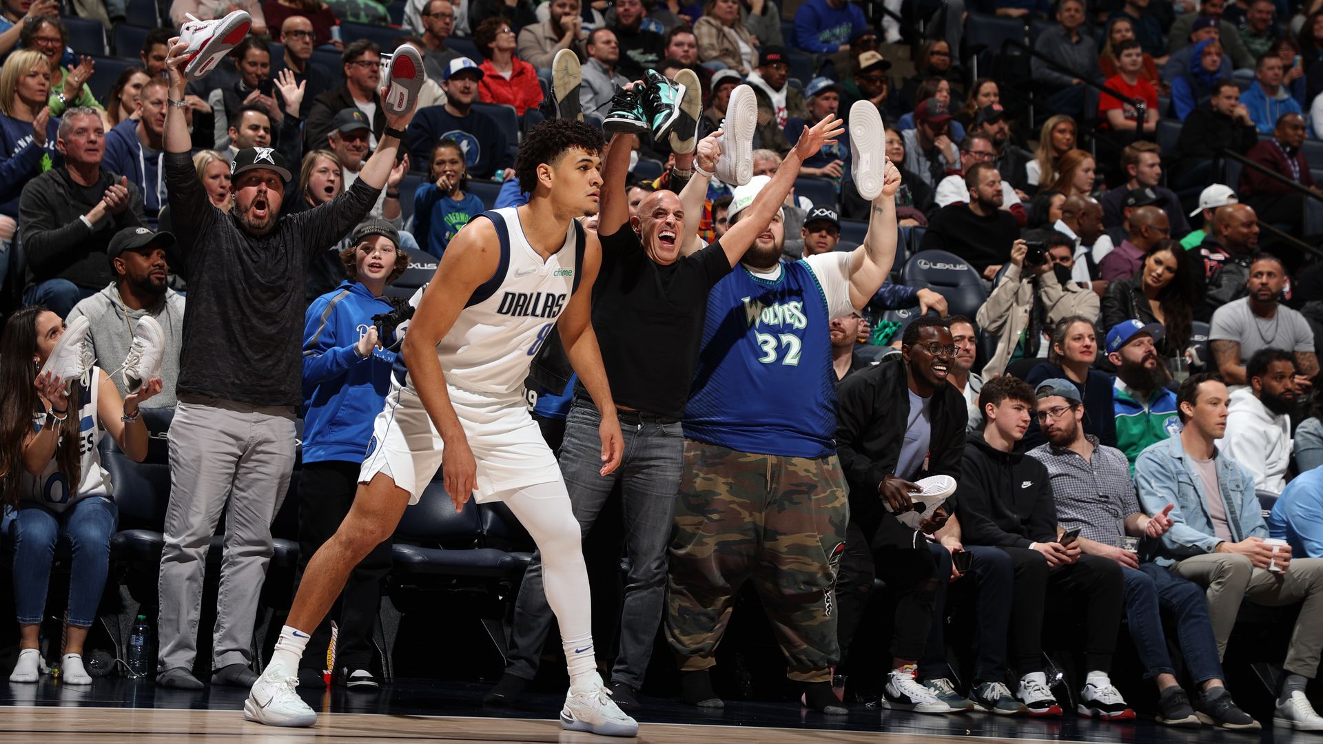 Marc Lore and fans hold their shoes in the air 