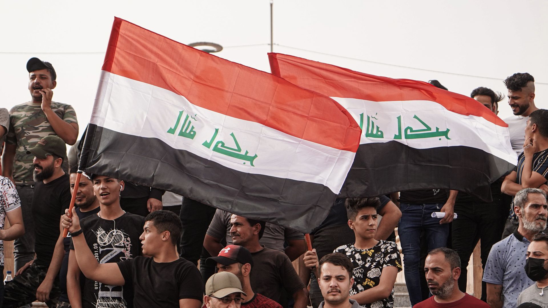 People in Mosul protest attack that killed nine tourists in northern Iraq. 