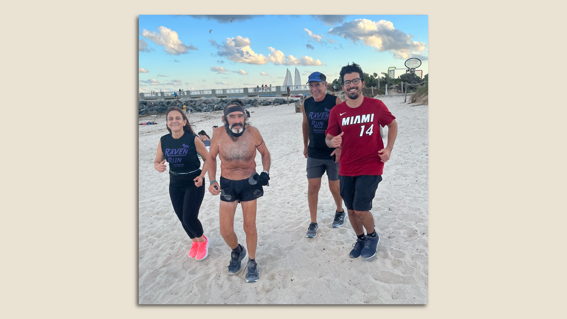 A group of runners jogs on the beach in Miami.