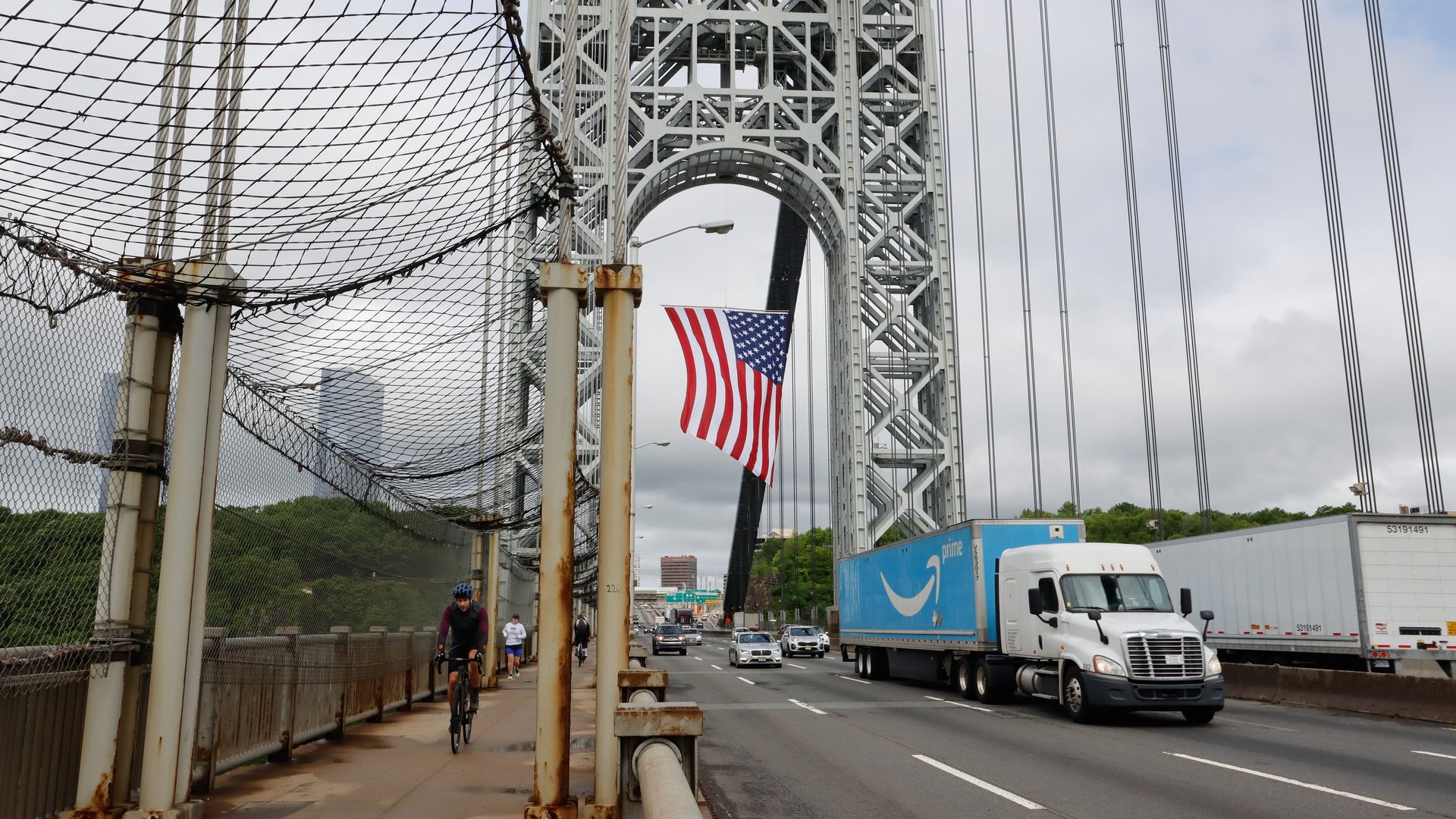 The George Washington Bridge hangs its 60 x 90-foot American flag from the New Jersey side tower to mark Memorial Day as an Amazon truck heads to New York City on May 31, 2021 in Ft. Lee, New Jersey. 