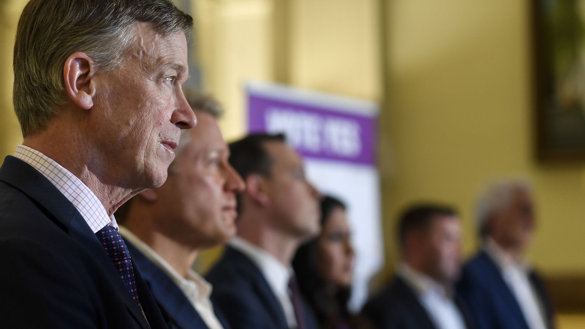 Kent Thiry, second from left, stands with former Gov. John Hickenlooper, far left, and state lawmakers. Photo: AAron Ontiveroz/The Denver Post via Getty Images