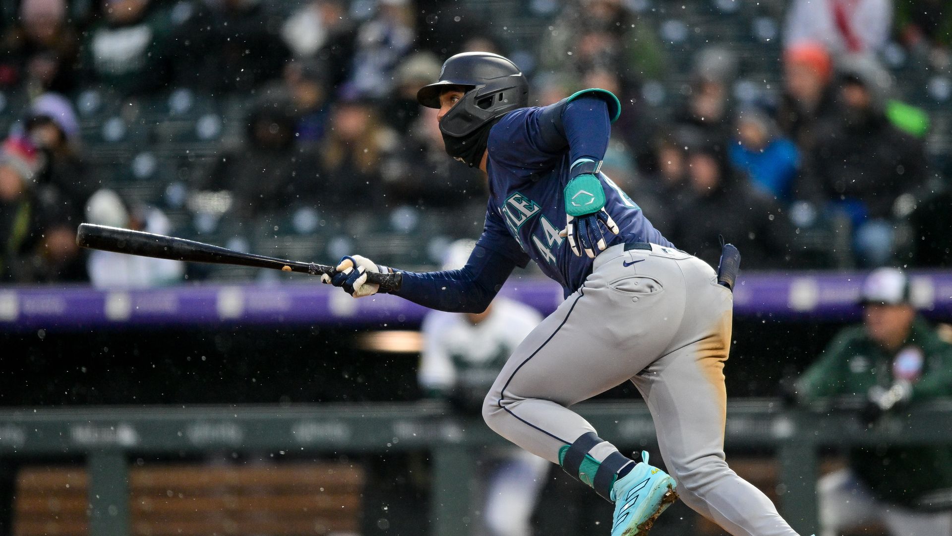 A Seattle Mariners baseball player takes off from the plate after hitting a single. 