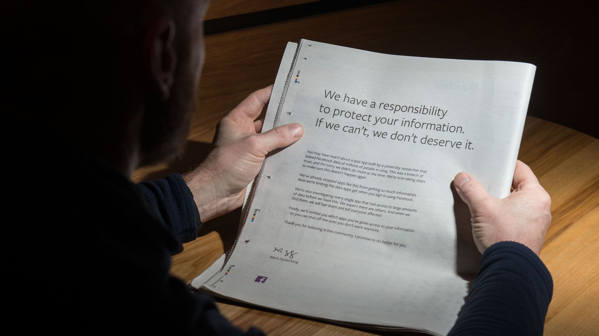 A man reads Facebook's full-page ad from this weekend