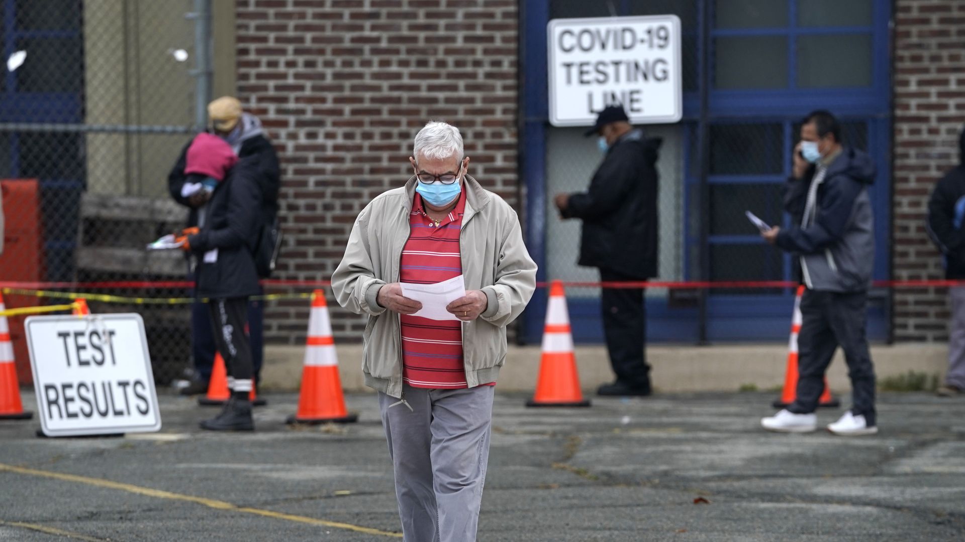 People wait in line to get tested for Covid-19 at the Ann Street School Covid-19 Testing Center in Newark, New Jersey