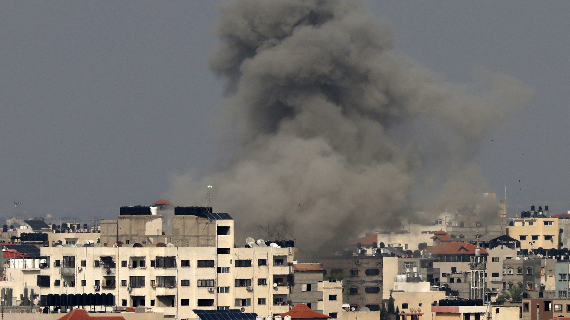 Smoke rises from buildings in Gaza City on May 12, 2023, after an Israeli air trike. Photo: Mahmud Haz/AFP via Getty Images