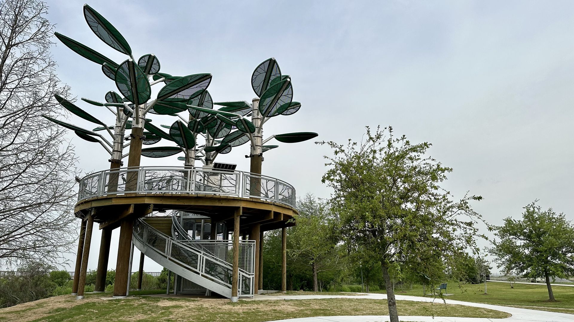 Photo shows a two-story viewing platform on Lake Pontchartrain that's supported by tree sculptures.