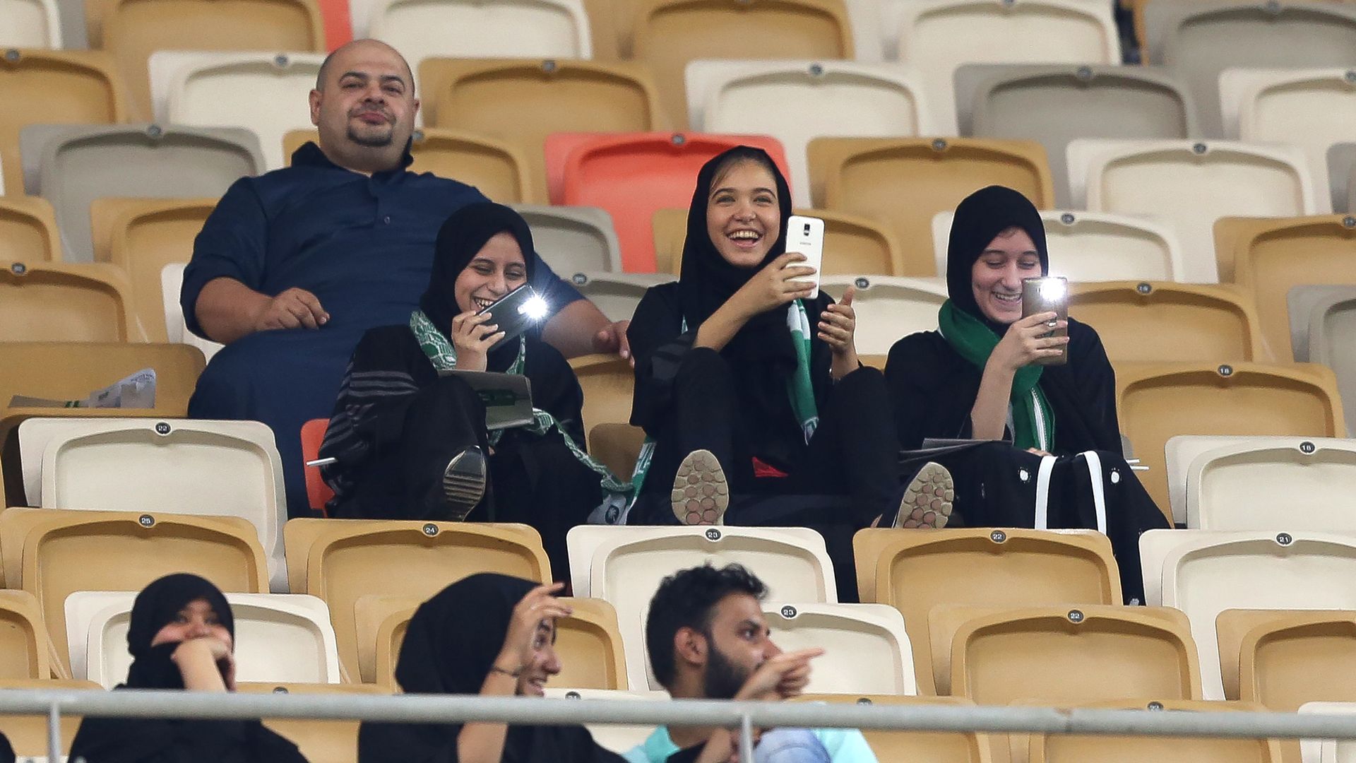 Female Saudi supporters attend their teams football match in the Saudi Pro League at the King Abdullah Sports City.