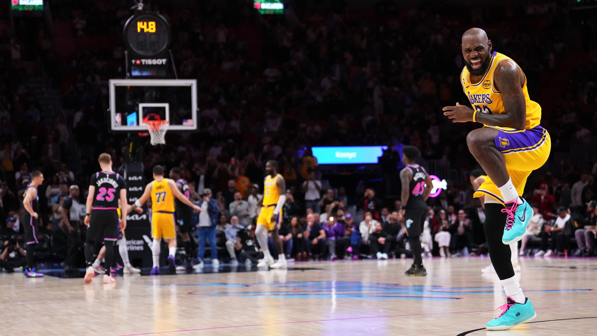 LeBron James in Lakers jersey laughing and skipping while other team shoots free throw