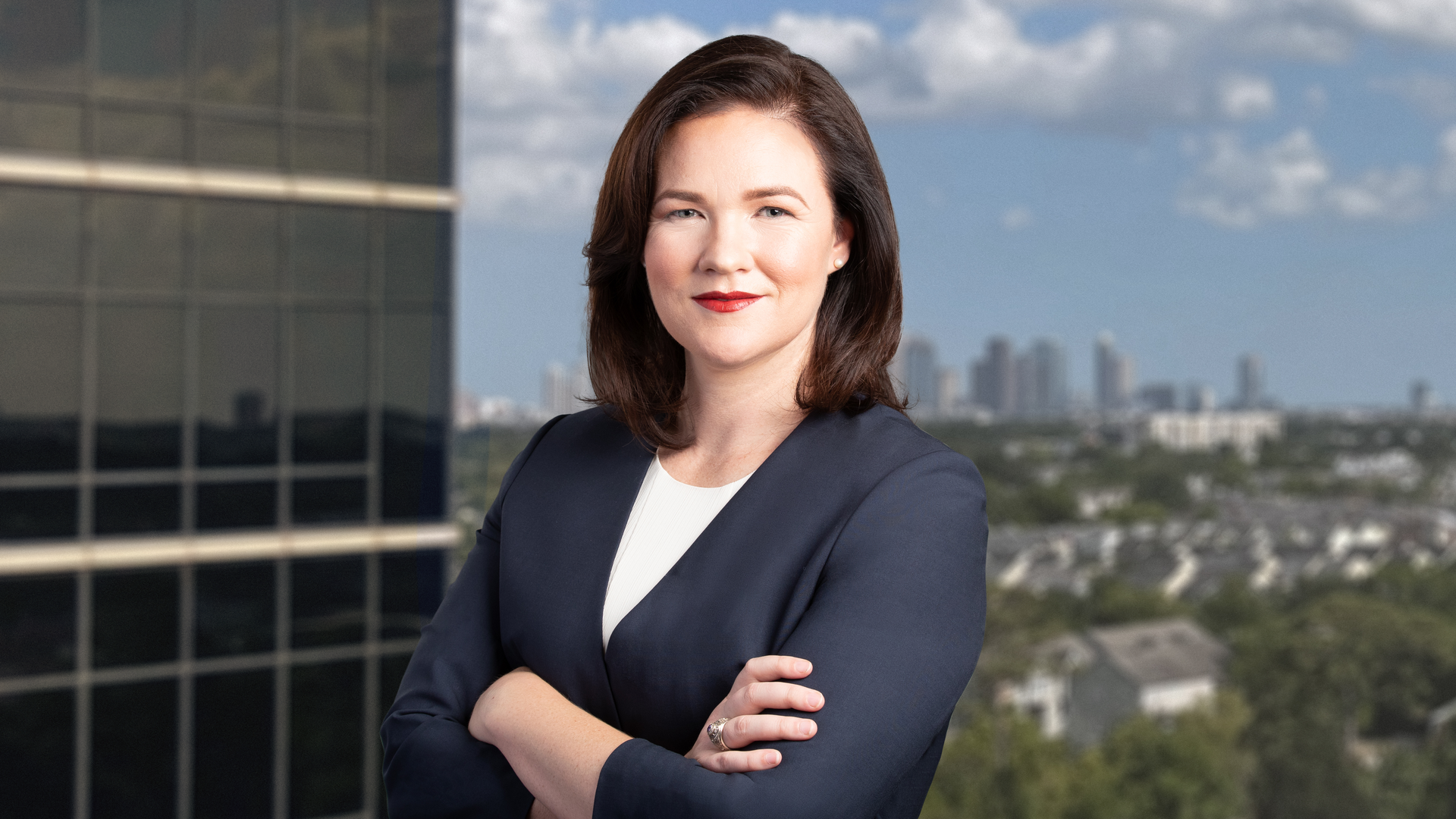 Republican Harris County judge candidate Alexandra Mealer poses with downtown Houston in the background