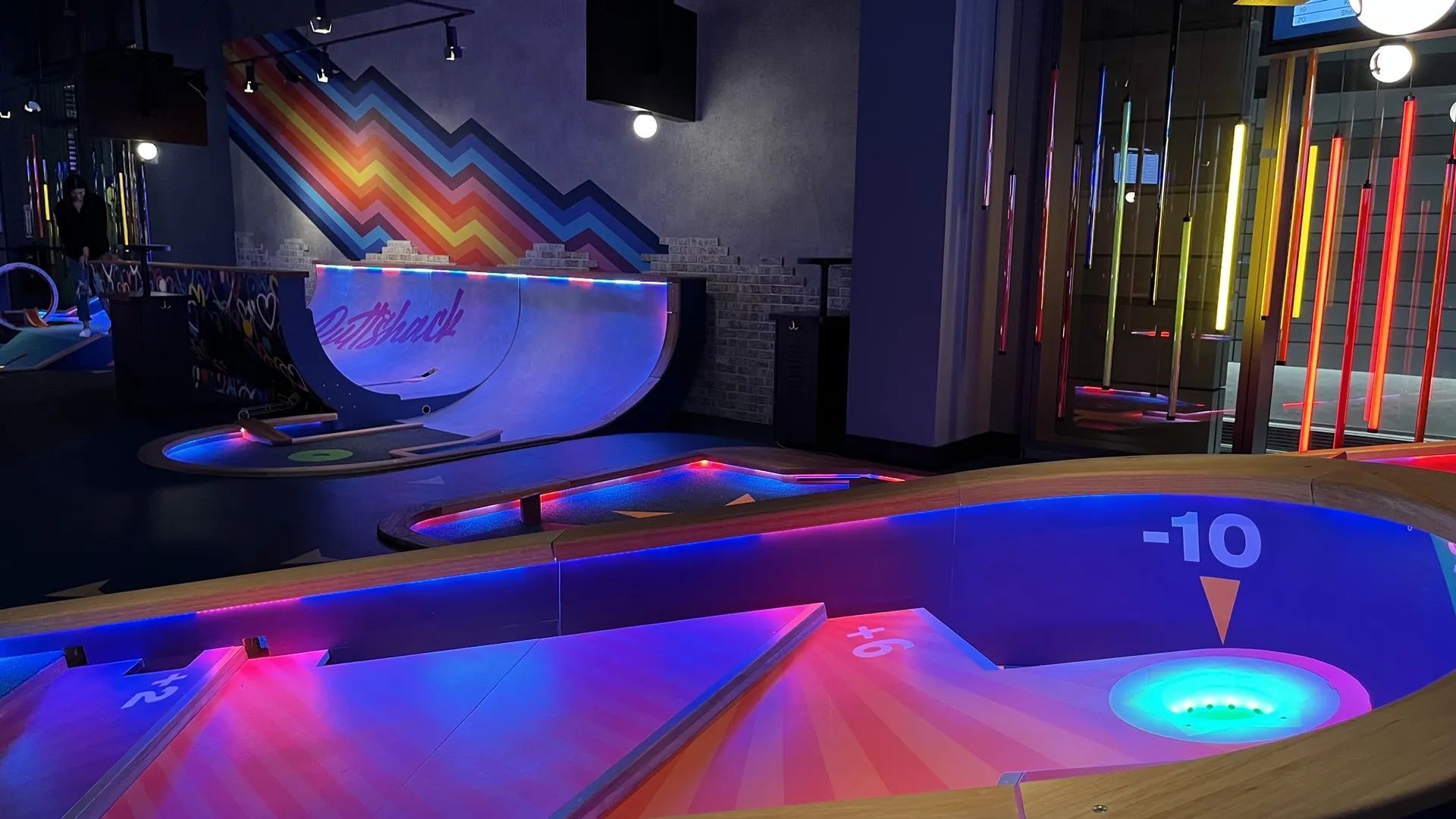 A mini golf course with neon lights