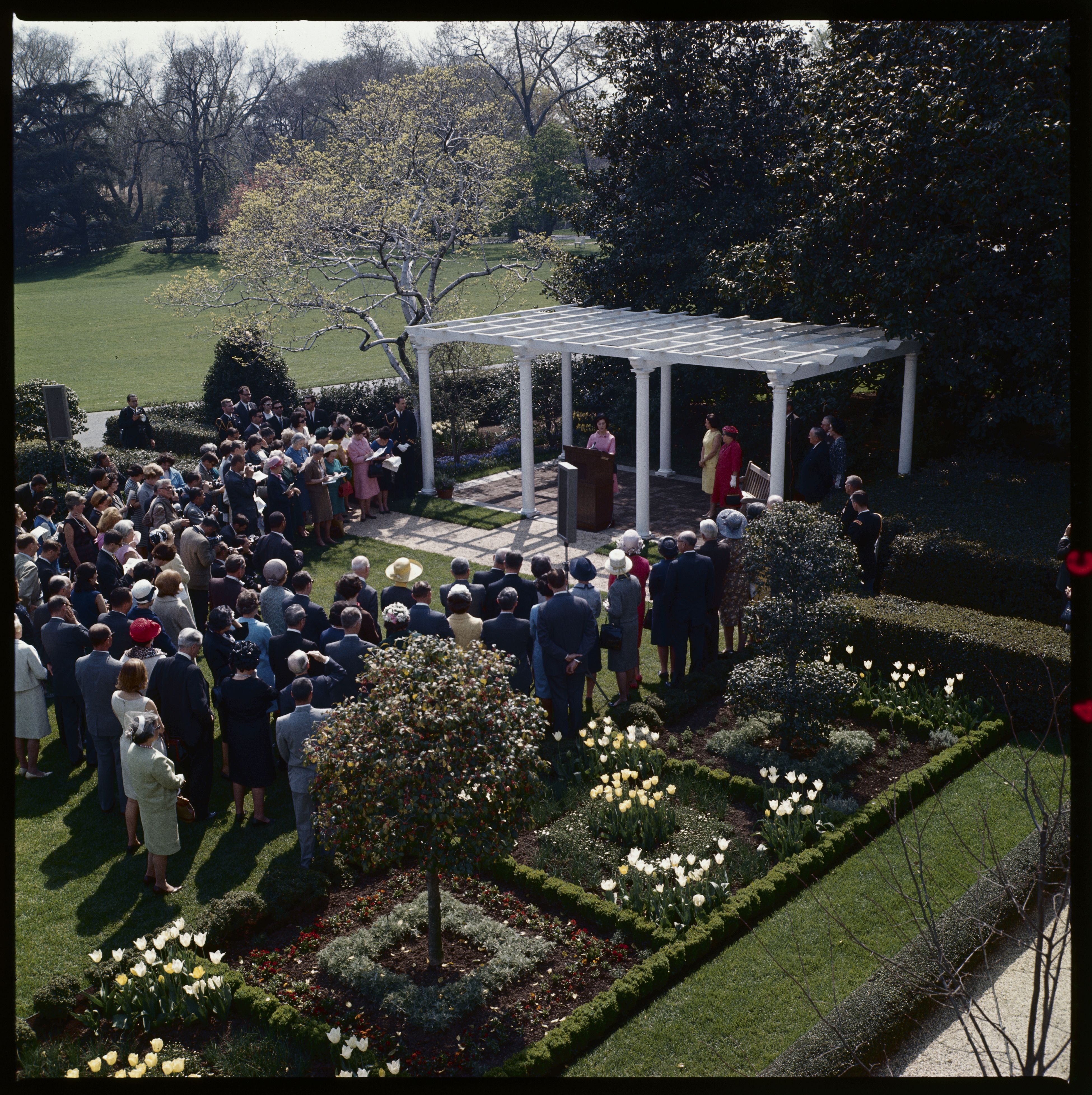 A crowd gathers as Lady Bird Johnson dedicates the Jacqueline Kennedy Garden.