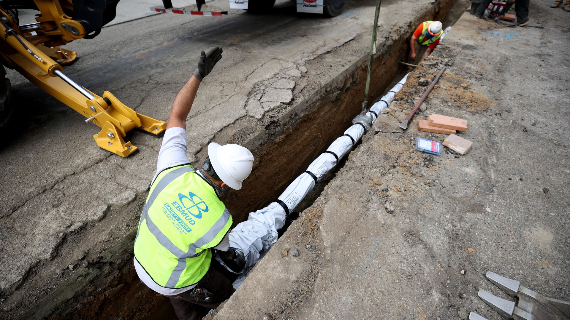 Utility workers installing a new pipe in Oakland, California, in April 2021.