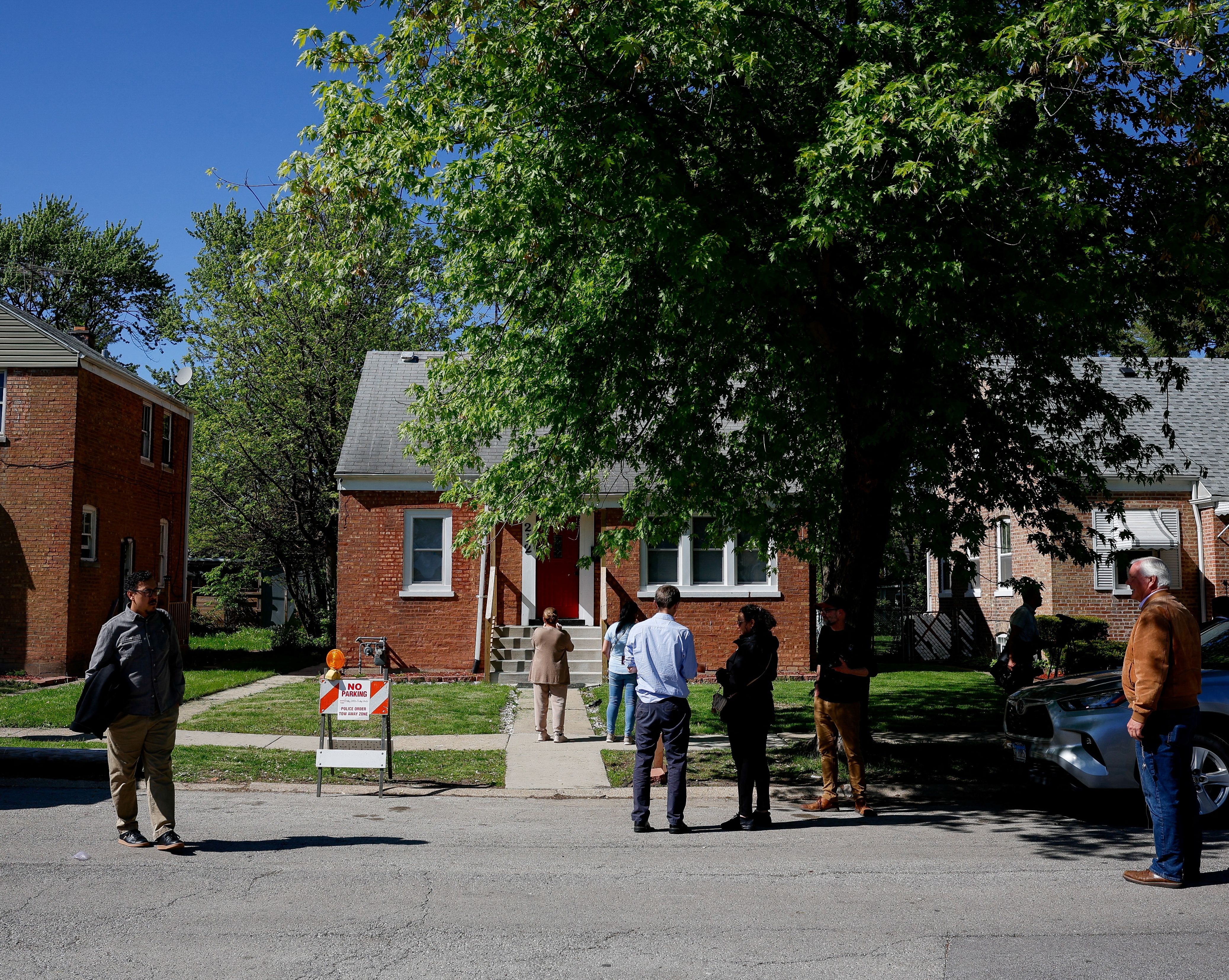 People stand in front of the childhood home of Pope Leo XIV in Dolton, Il.