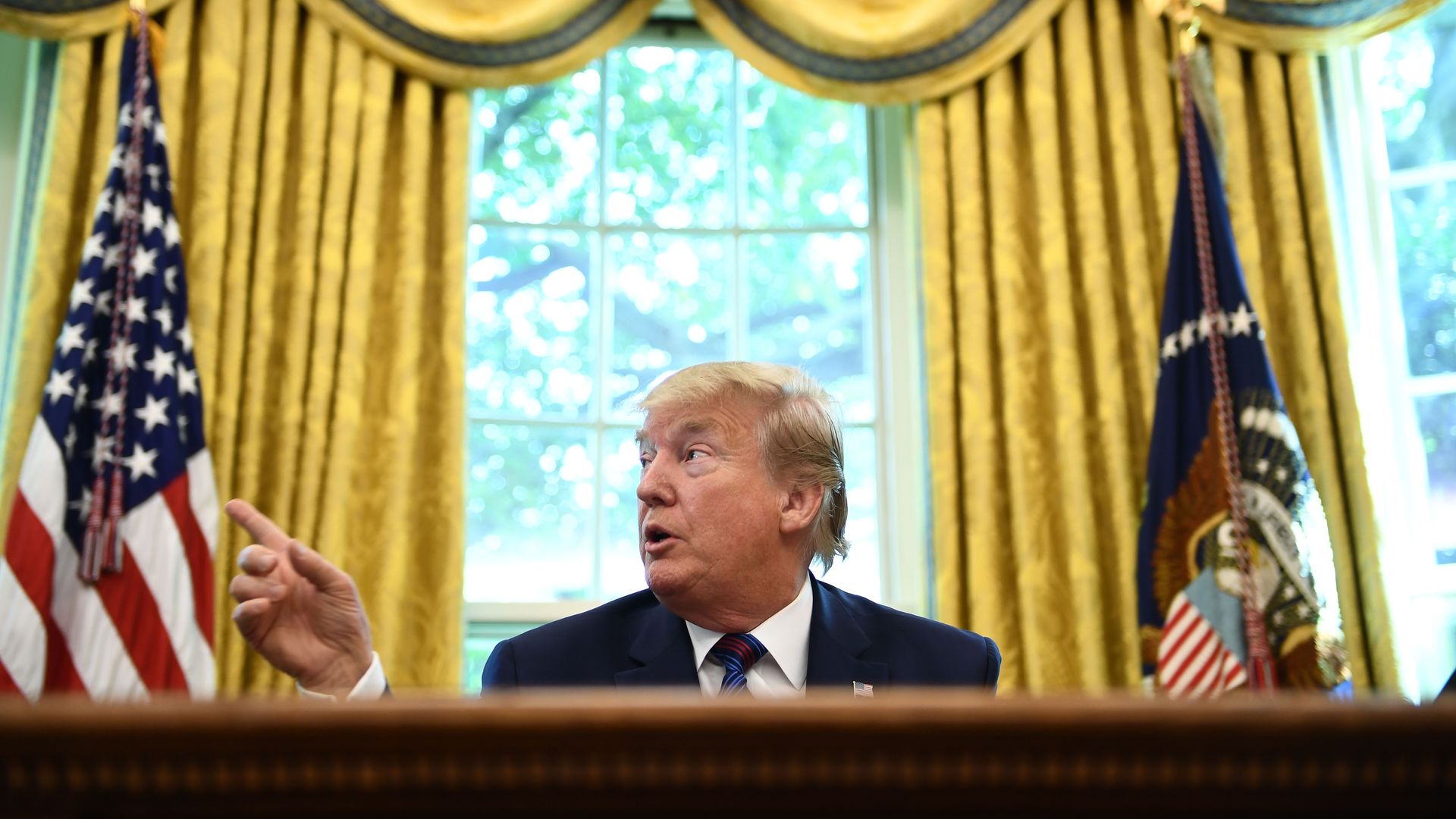  President Donald Trump speaks to the media in the Oval Office of the White House in Washington, DC