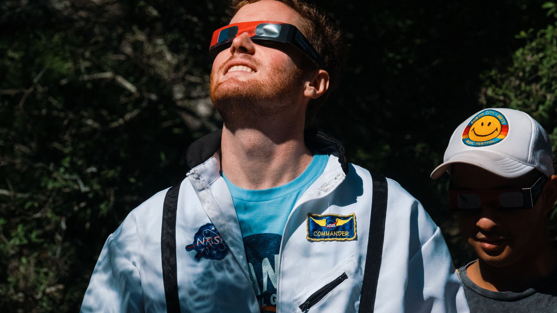 Spectator wear solar viewing glasses during a solar eclipse