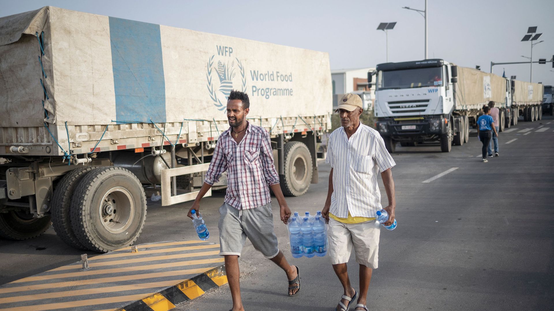Truck drivers carry bottles of water 