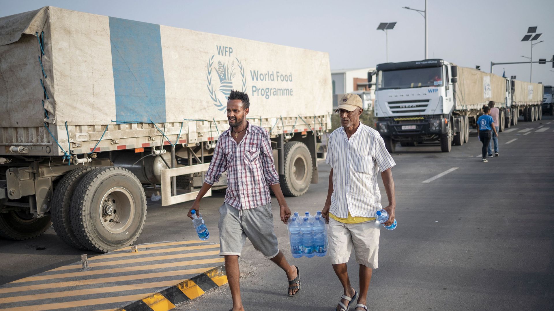 Truck drivers carry bottles of water