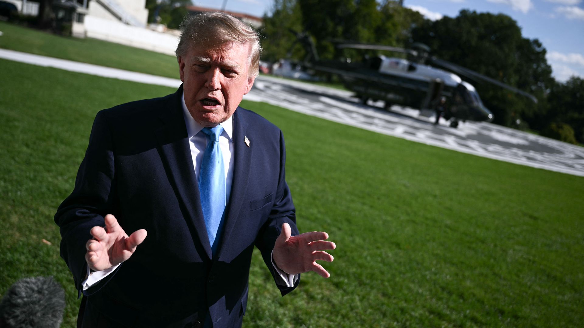 President Trump speaks to reporters outside the White House.
