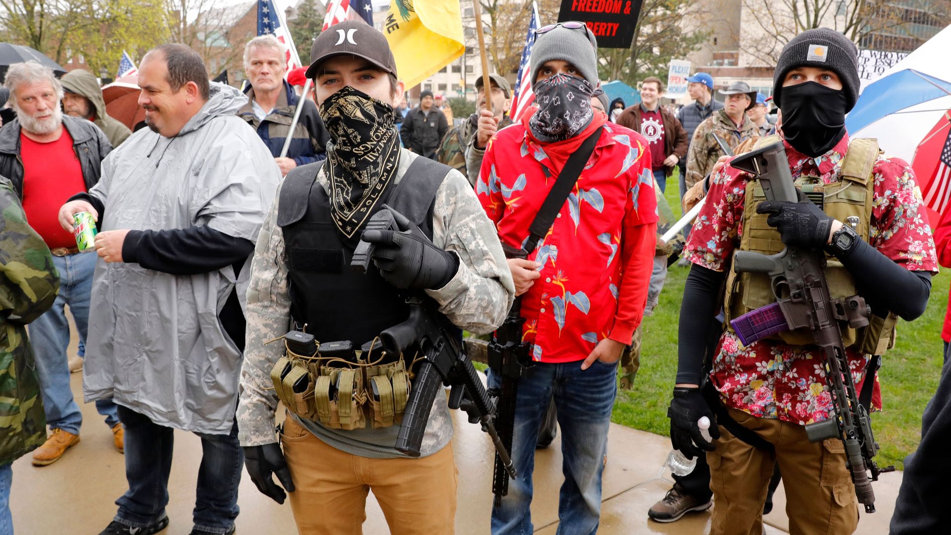 Armed protesters provide security as demonstrators take part in an "American Patriot Rally,"