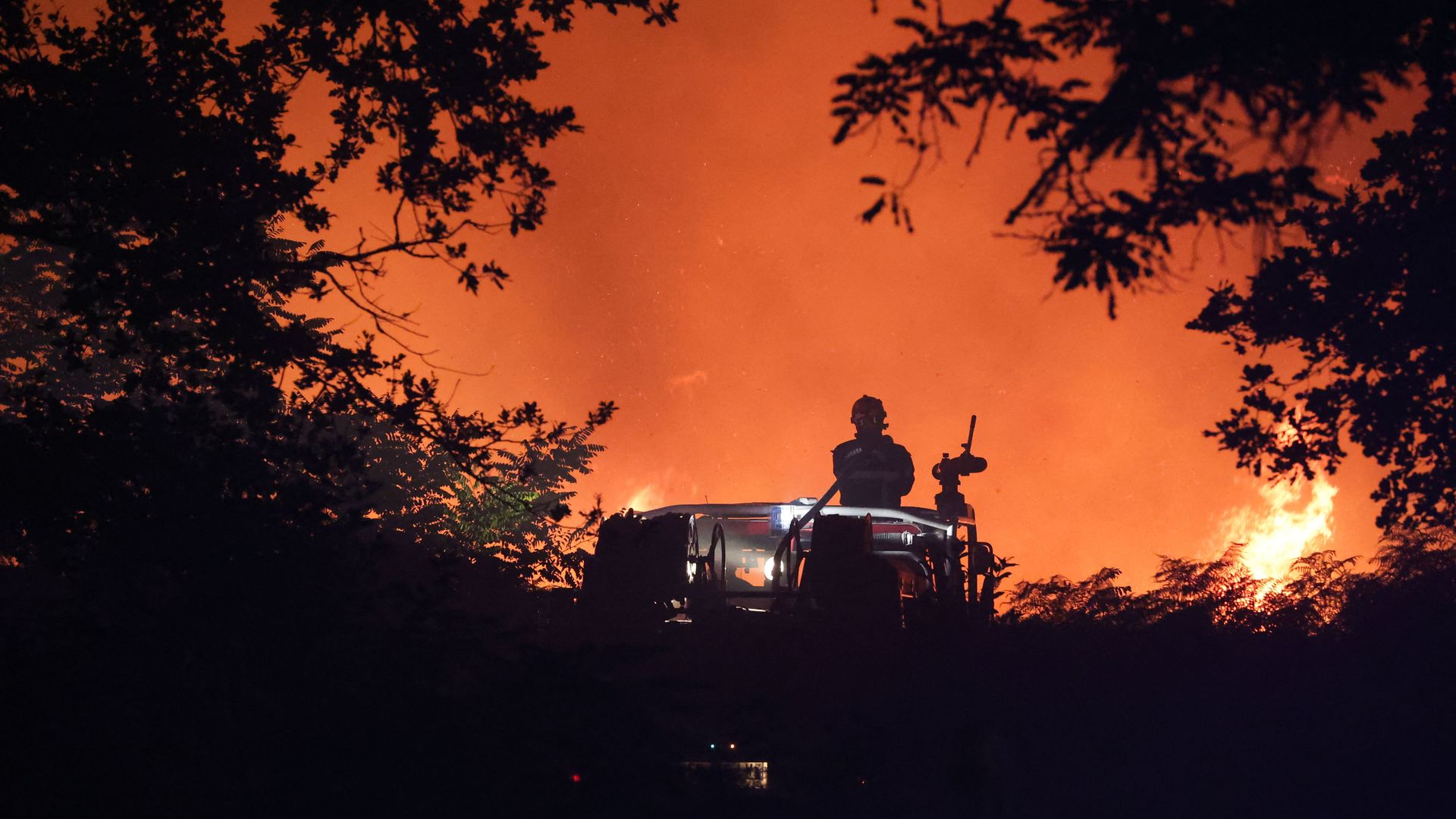 Firefighters attempt to control a forest fire spread 