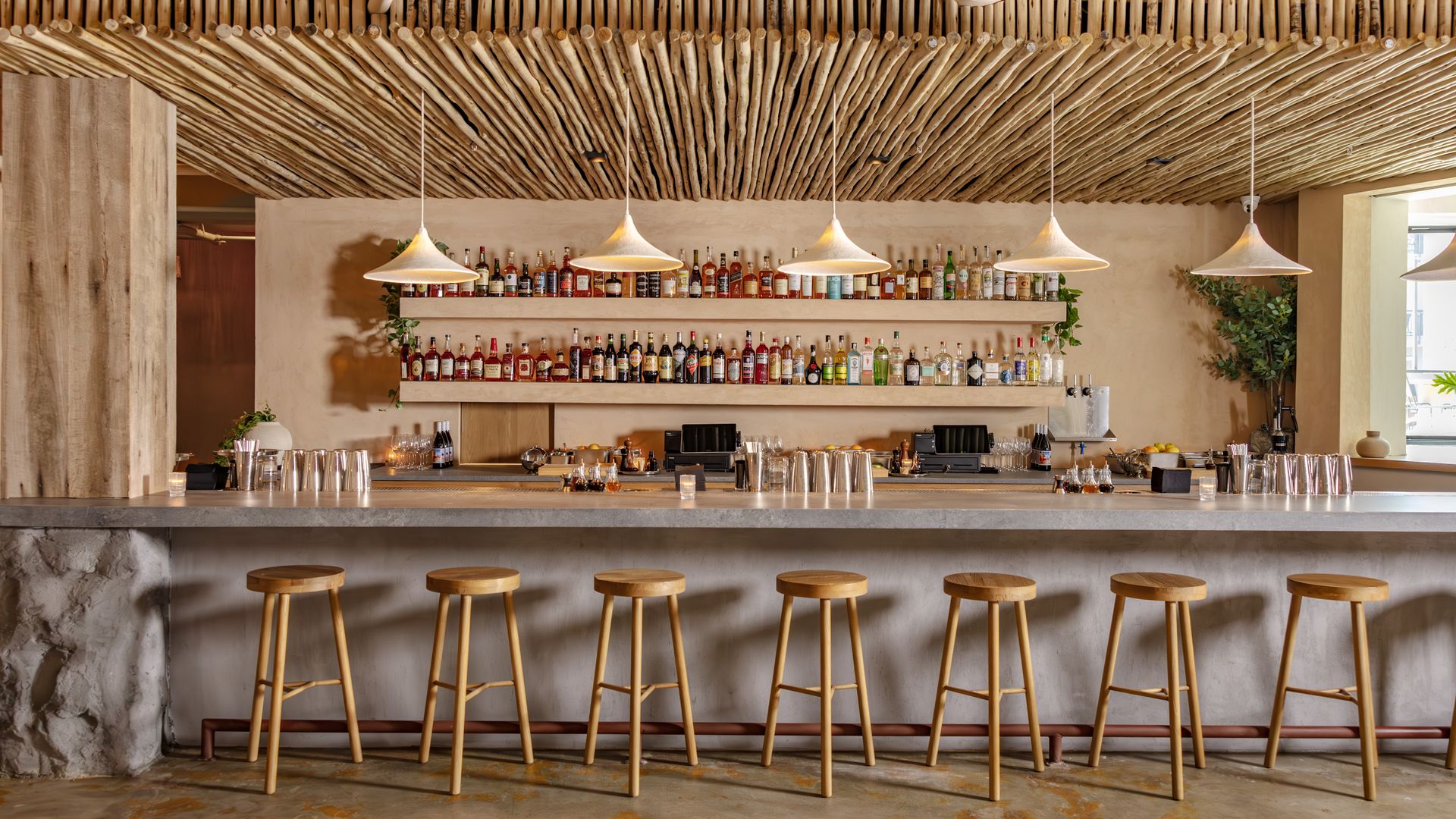 A bar stocked with dozens of bottles.