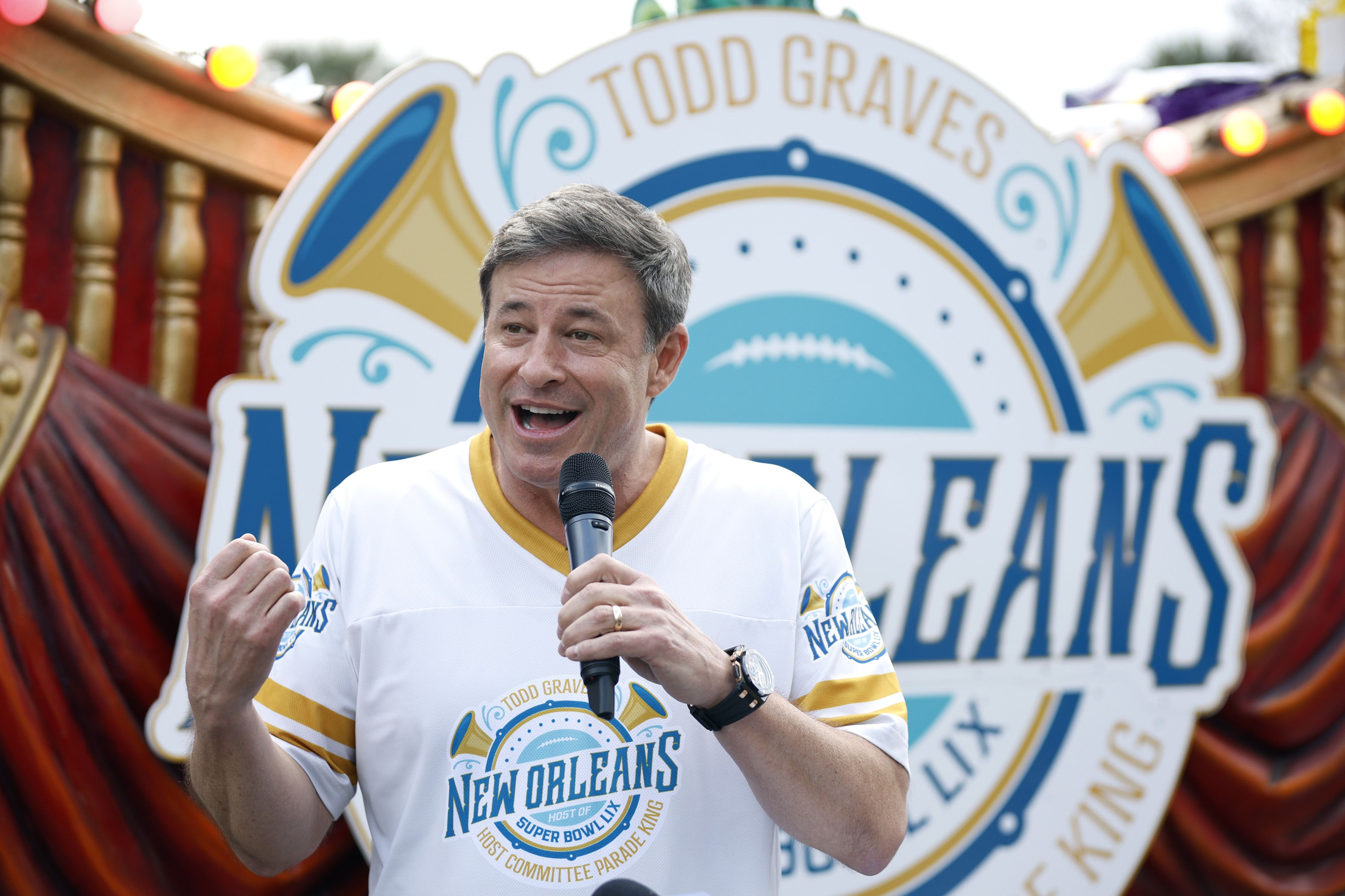 Photo shows Todd Graves with a microphone.