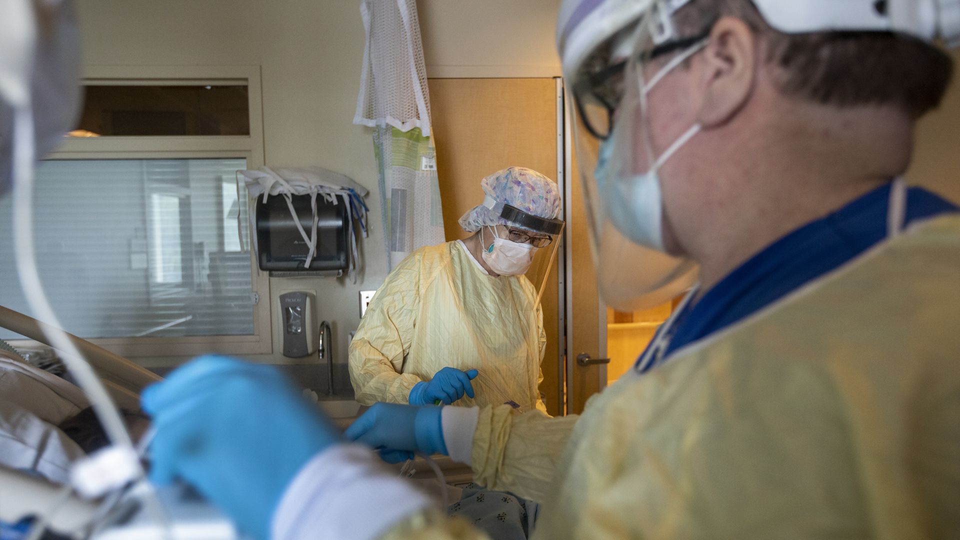 Nurses reposition a patient in the ICU 