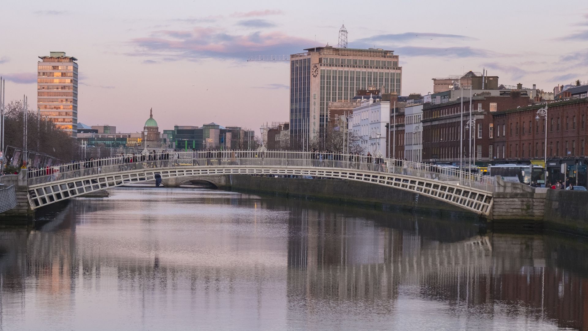 A view towards Ha'Penny Bridge in Dublin at sunset.