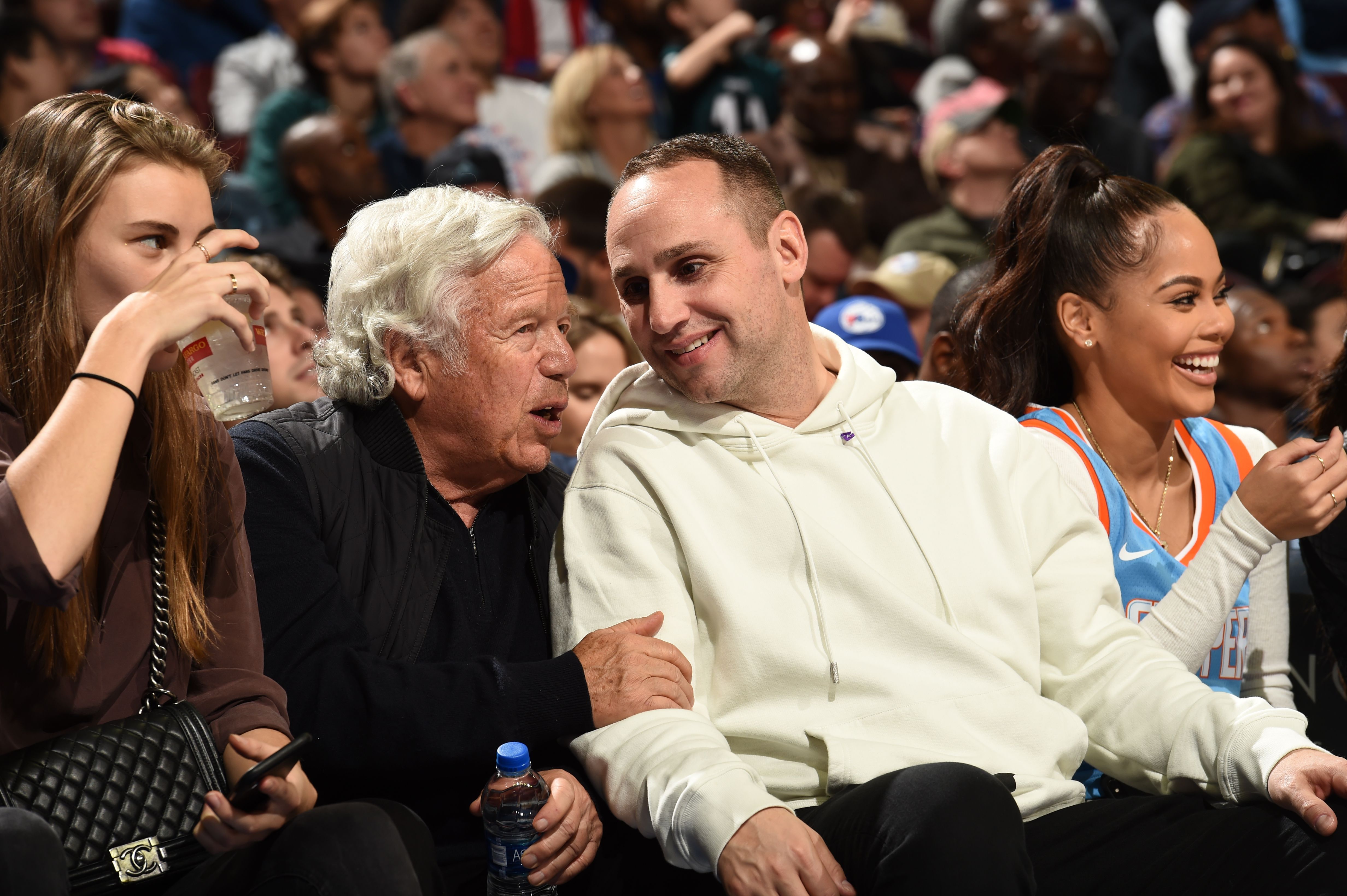 Fanatics CEO and 76ers co-owner Michael Rubin (R) speaks with Patriots owner Robert Kraft during a 76ers game in 2018.