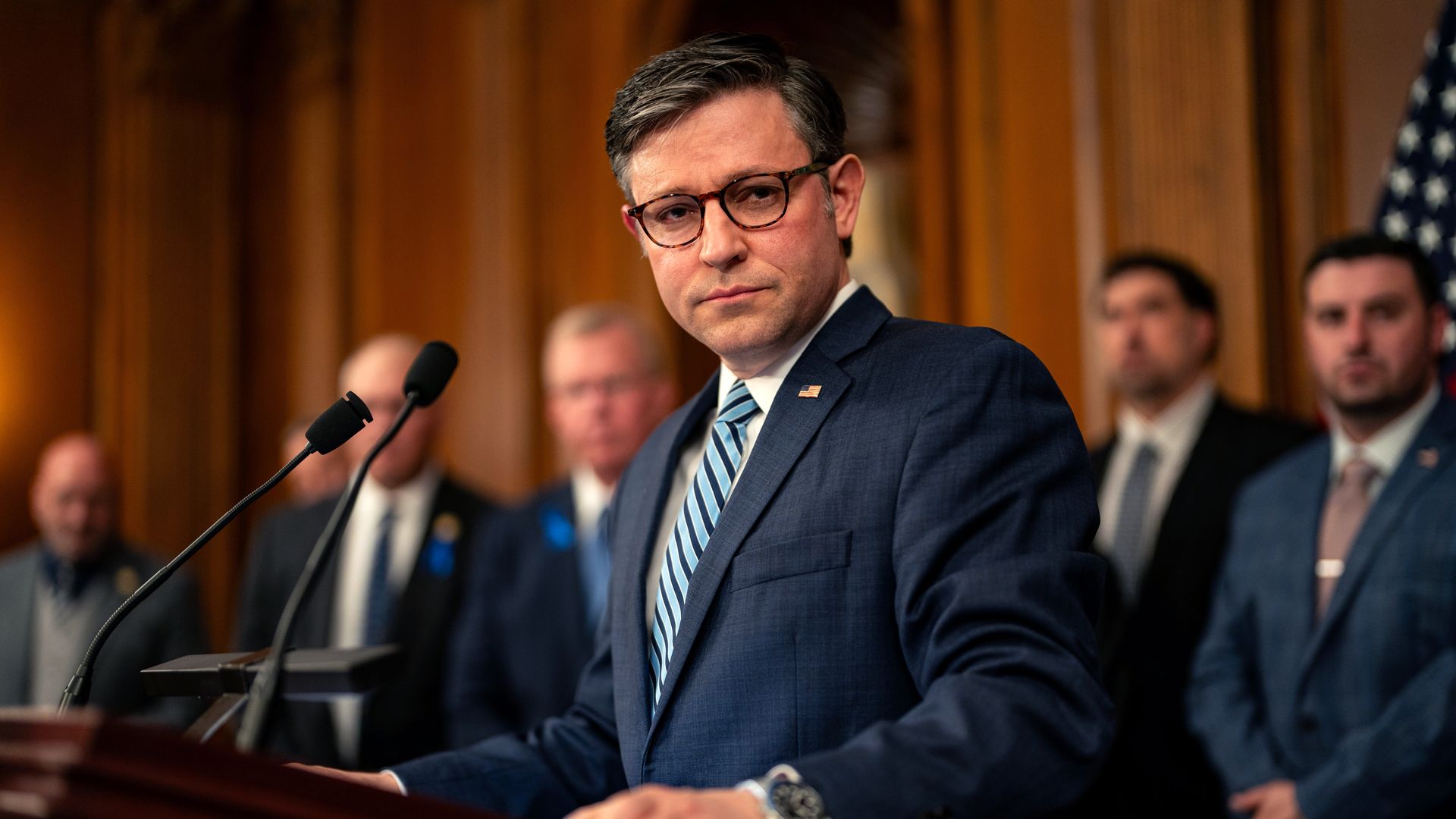 House Speaker Mike Johnson behind a podium