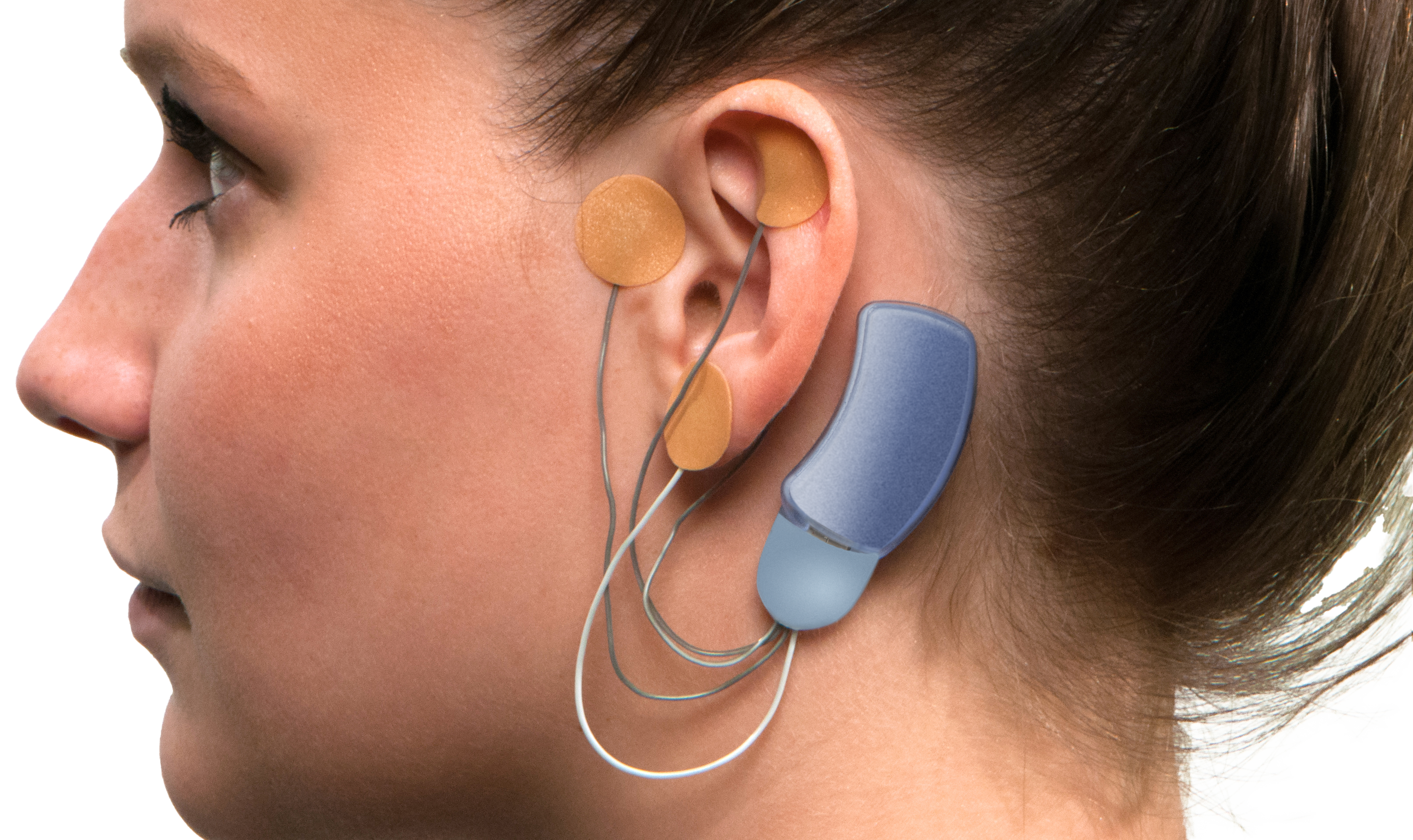 the side profile of a woman wearing the device which wraps around her ear.
