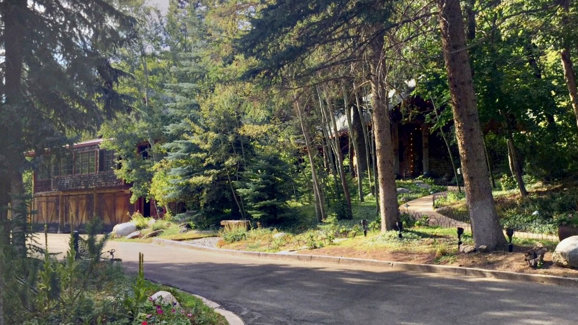 A log building on a mountain road. 
