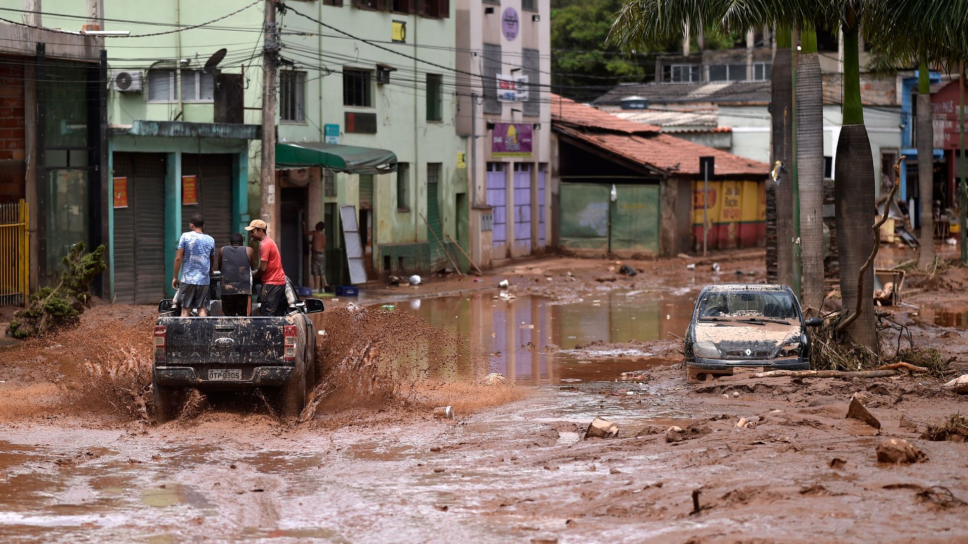 A truck rides along a flooded street after the overflowing of the Das Velhas River in Sabara