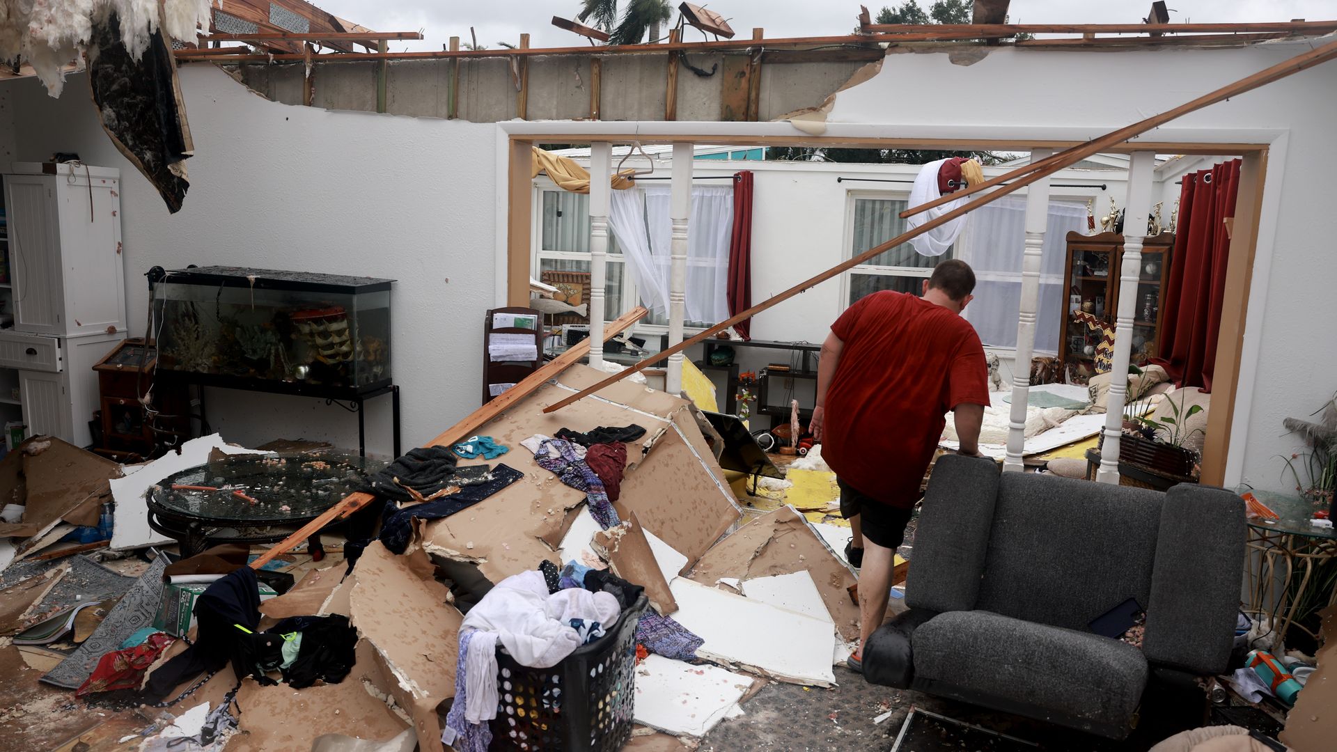 Robert Haight salvages what he can from his home after what appeared to be a tornado tore the roof off before Hurricane Milton's arrival on October 09, 2024, in Fort Myers, Florida. 