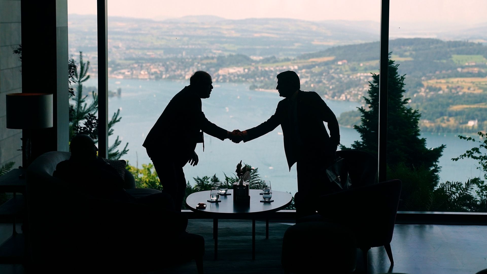 Delegation staff members stand and talk in the lobby of the Bürgenstock Resort during the Lake Lucerne Summit in Switzerland.