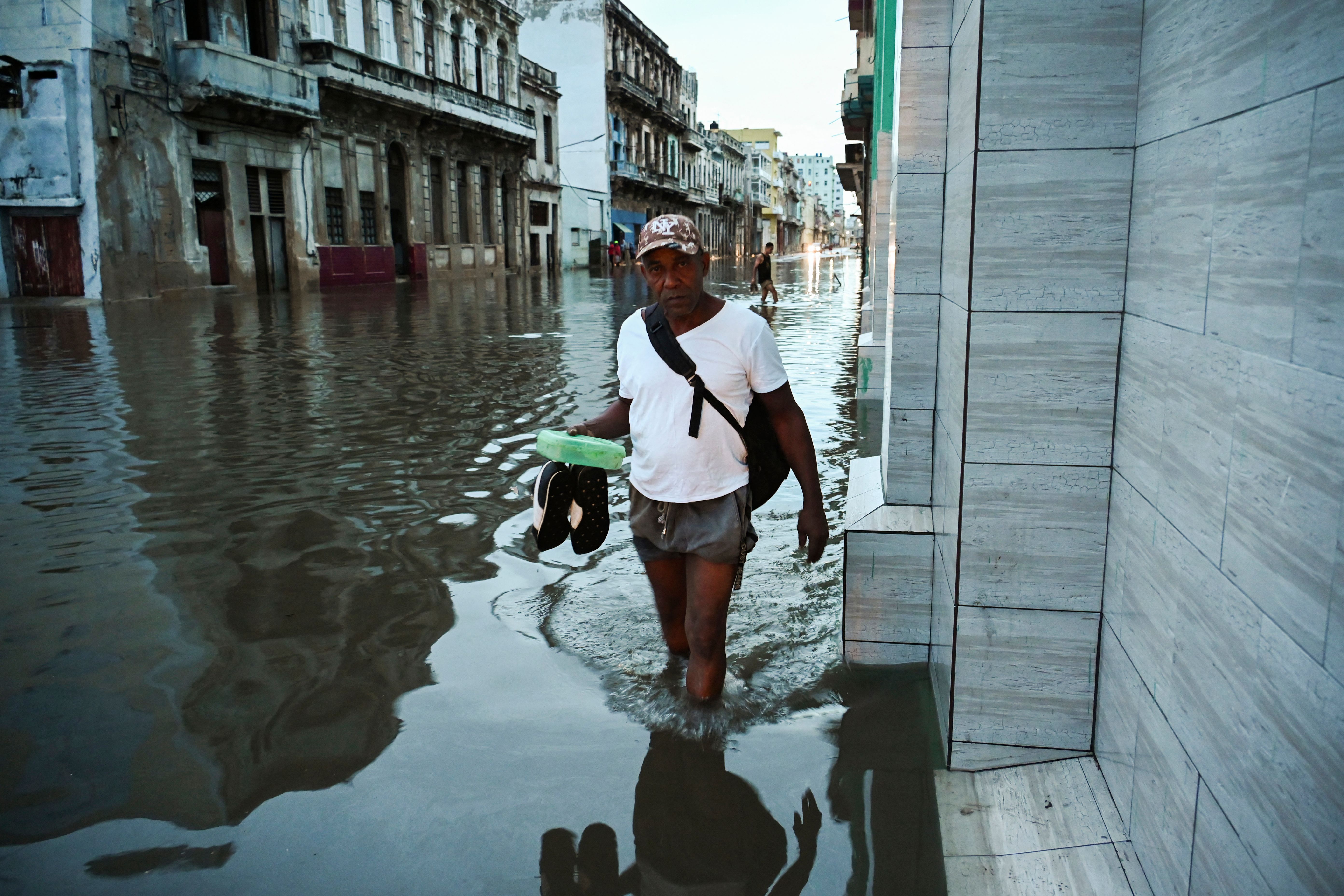 man standing in a flooded Cuba street