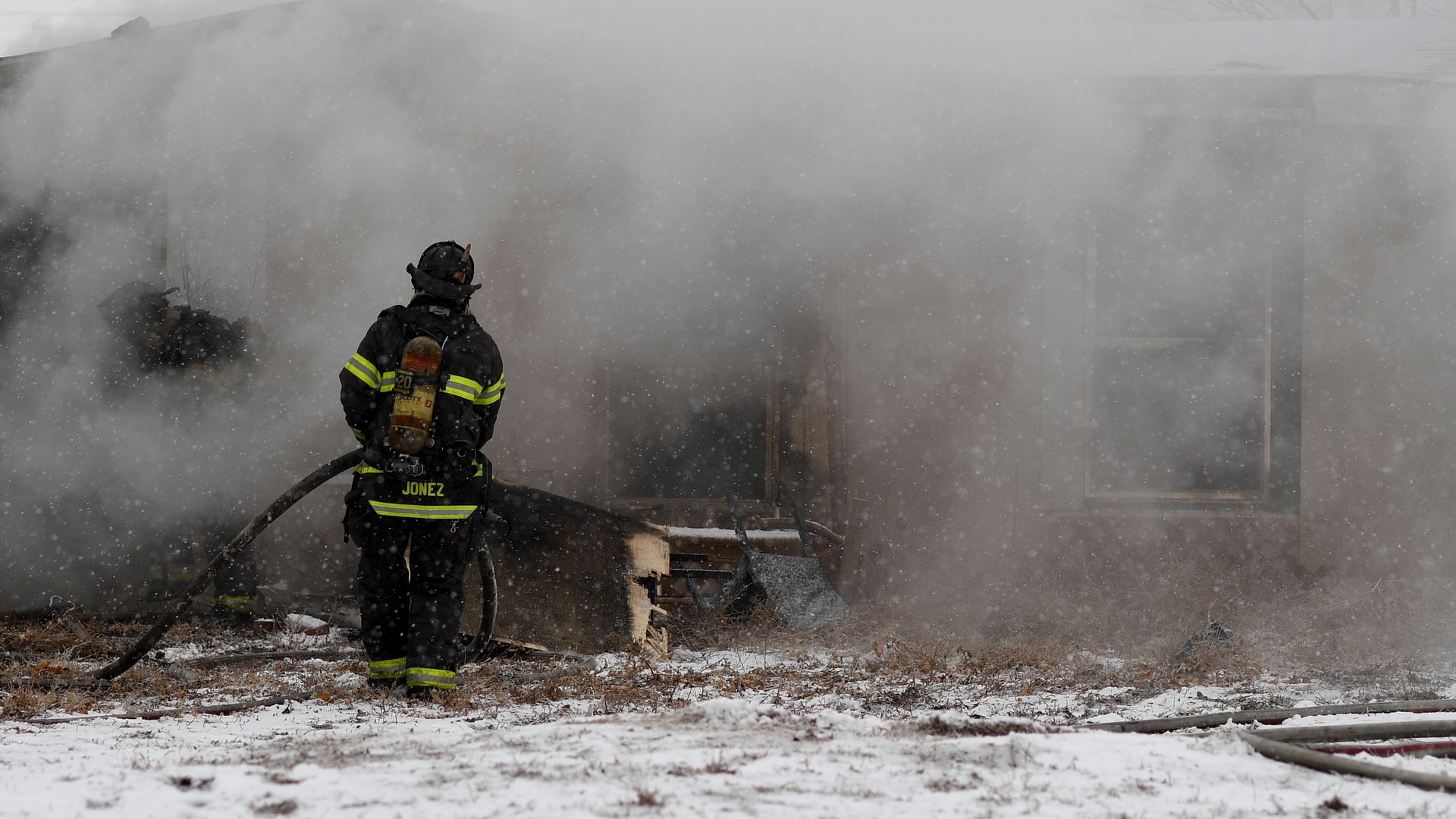 Denver Fire crews work in snow and cold to put out a house fire at the 3100 block of S. Grove St. on February 3, 2020 in Denver