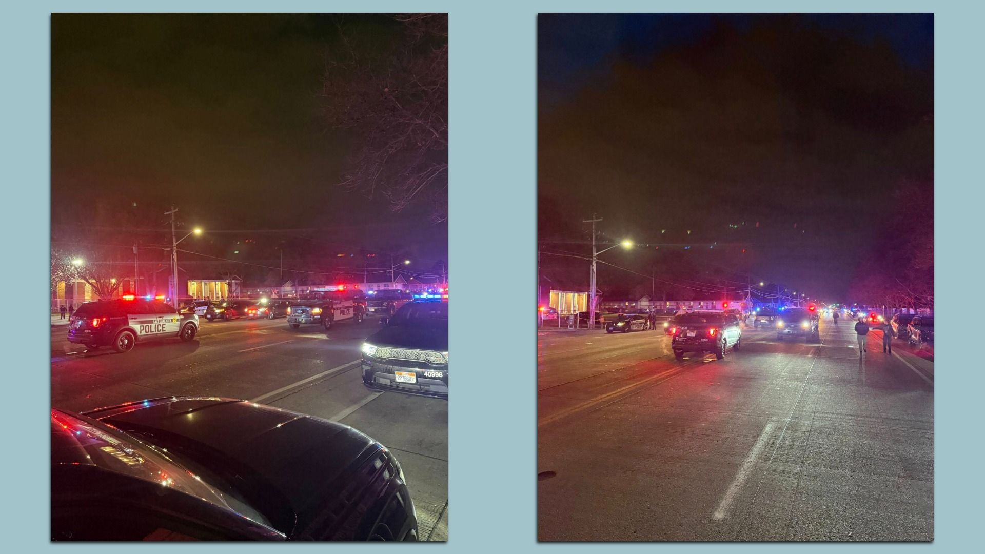 Night scene with multiple police vehicles flashing red and blue lights blocking a street, a few people walking nearby, and houses lit in the background.