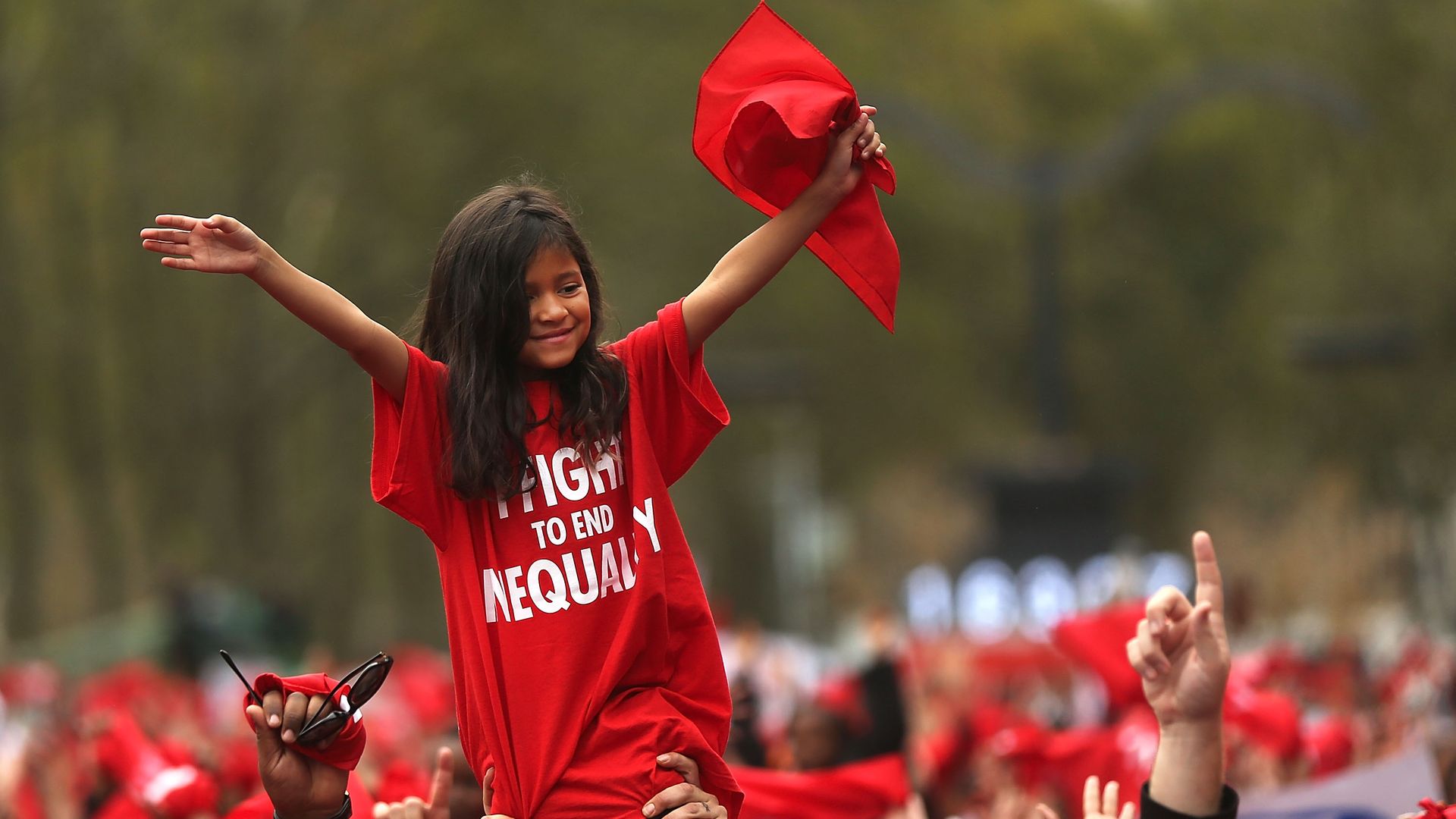 A Latina child raises her hands in the air and she is carried during a rally in Brooklyn over education inequality in New York City. 