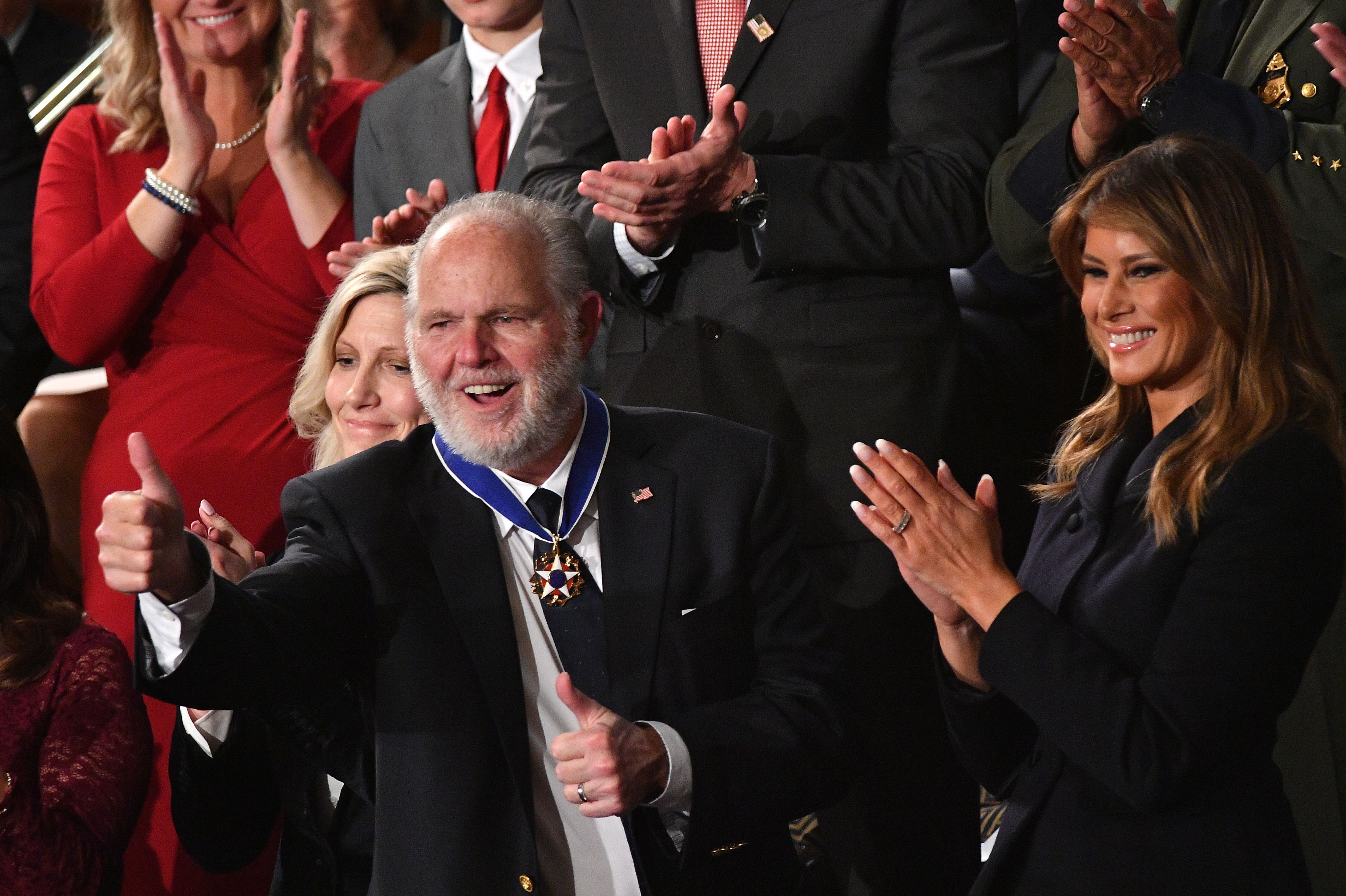 Radio personality Rush Limbaugh pumps thumb after being awarded the Medal of Freedom by First Lady Melania Trump after being acknowledged by US President Donald Trump
